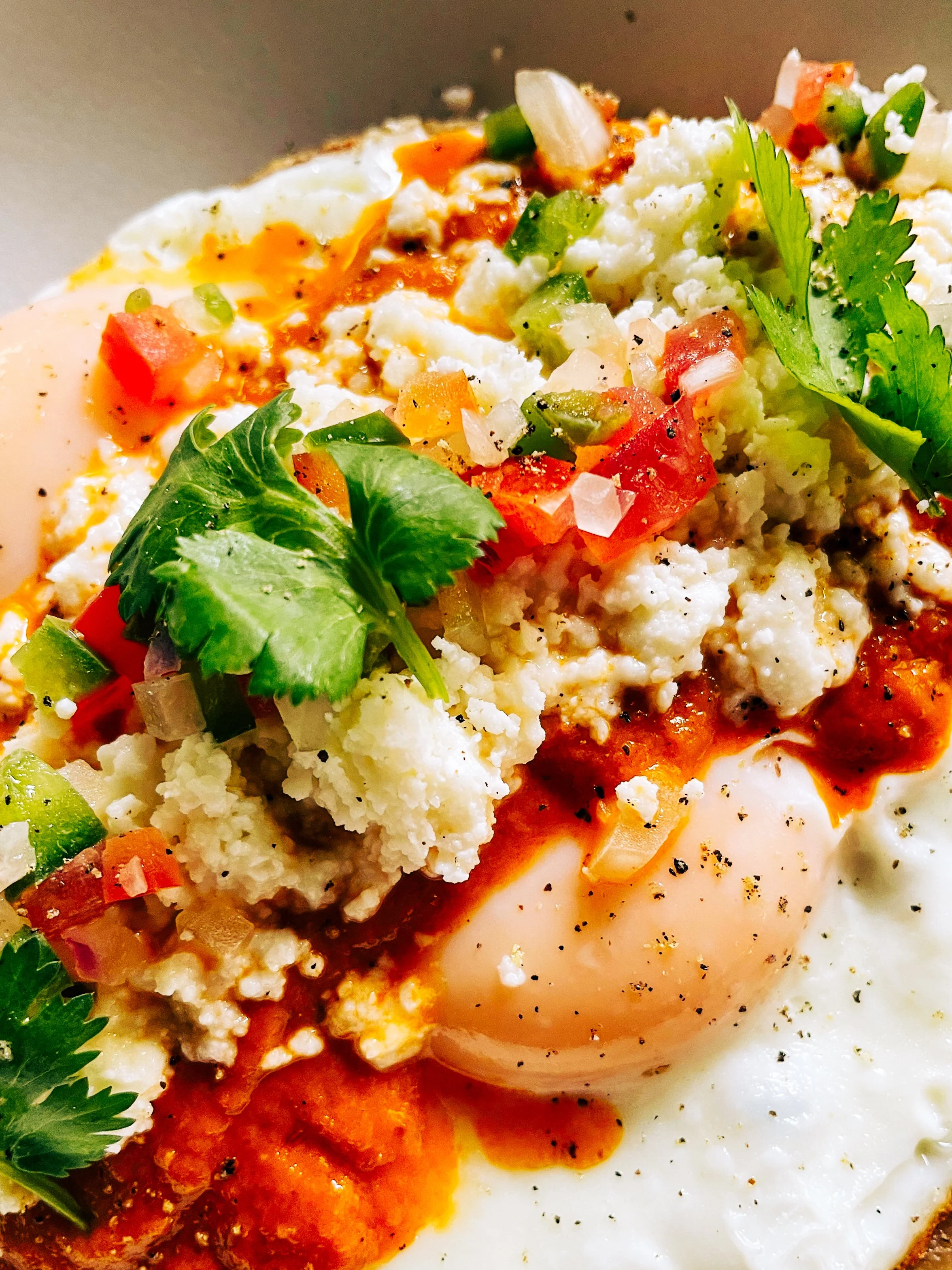 Plate of Huevos Rancheros with smothered in bright pico de gallo