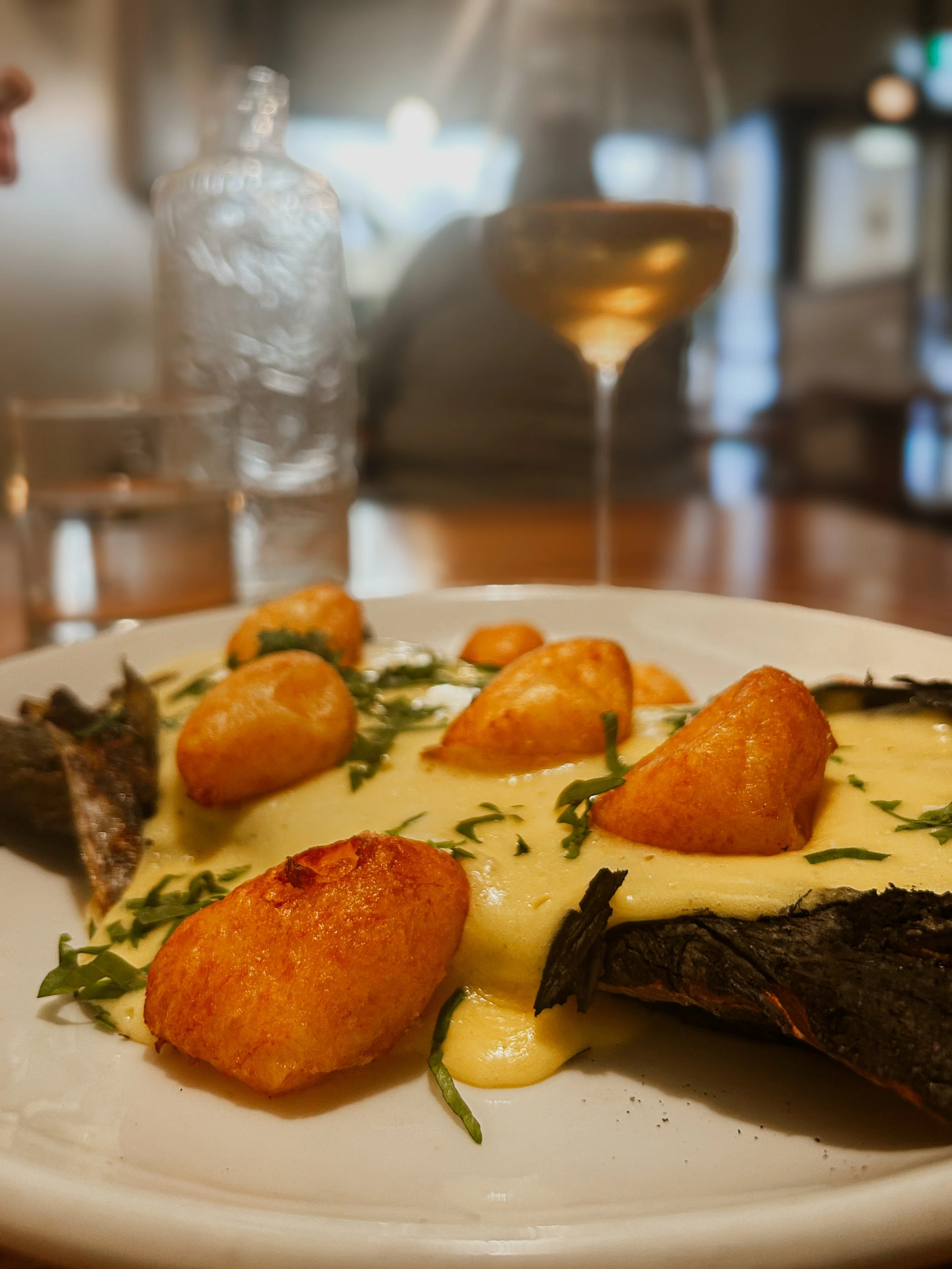 The Grilled Leak with potatoes and a glass of wine at Gatherings in Christchurch, New Zealand