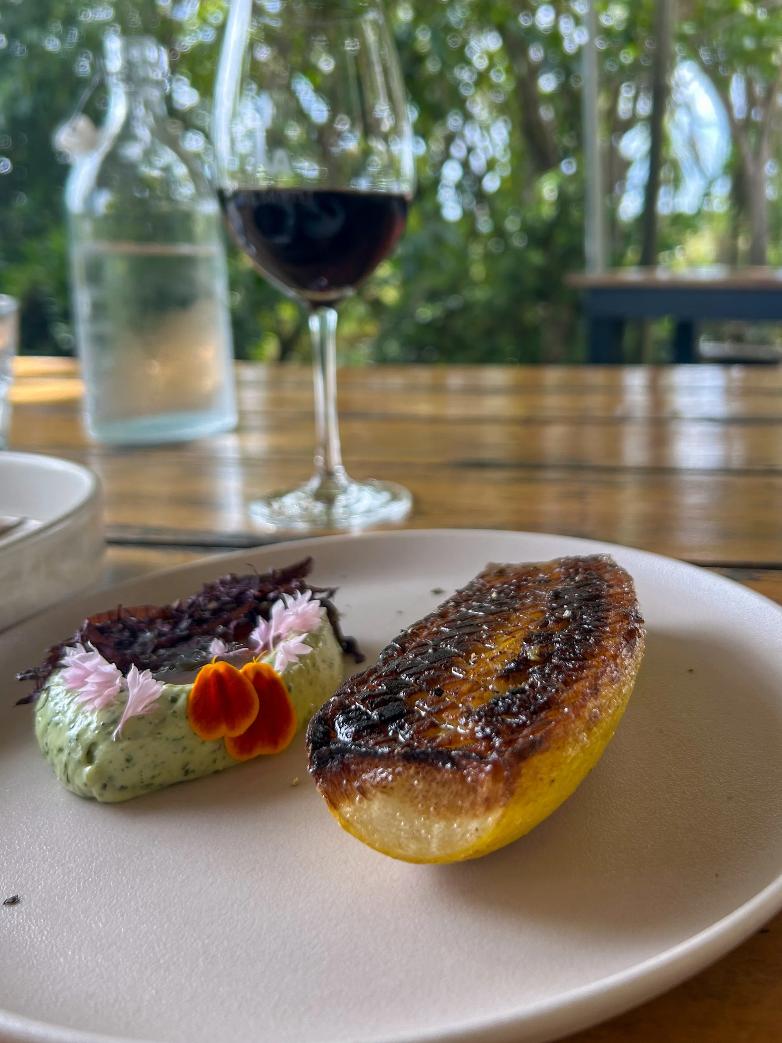 A colorful dish and glass of wine at Te Motu The Shed in Waiheke Island