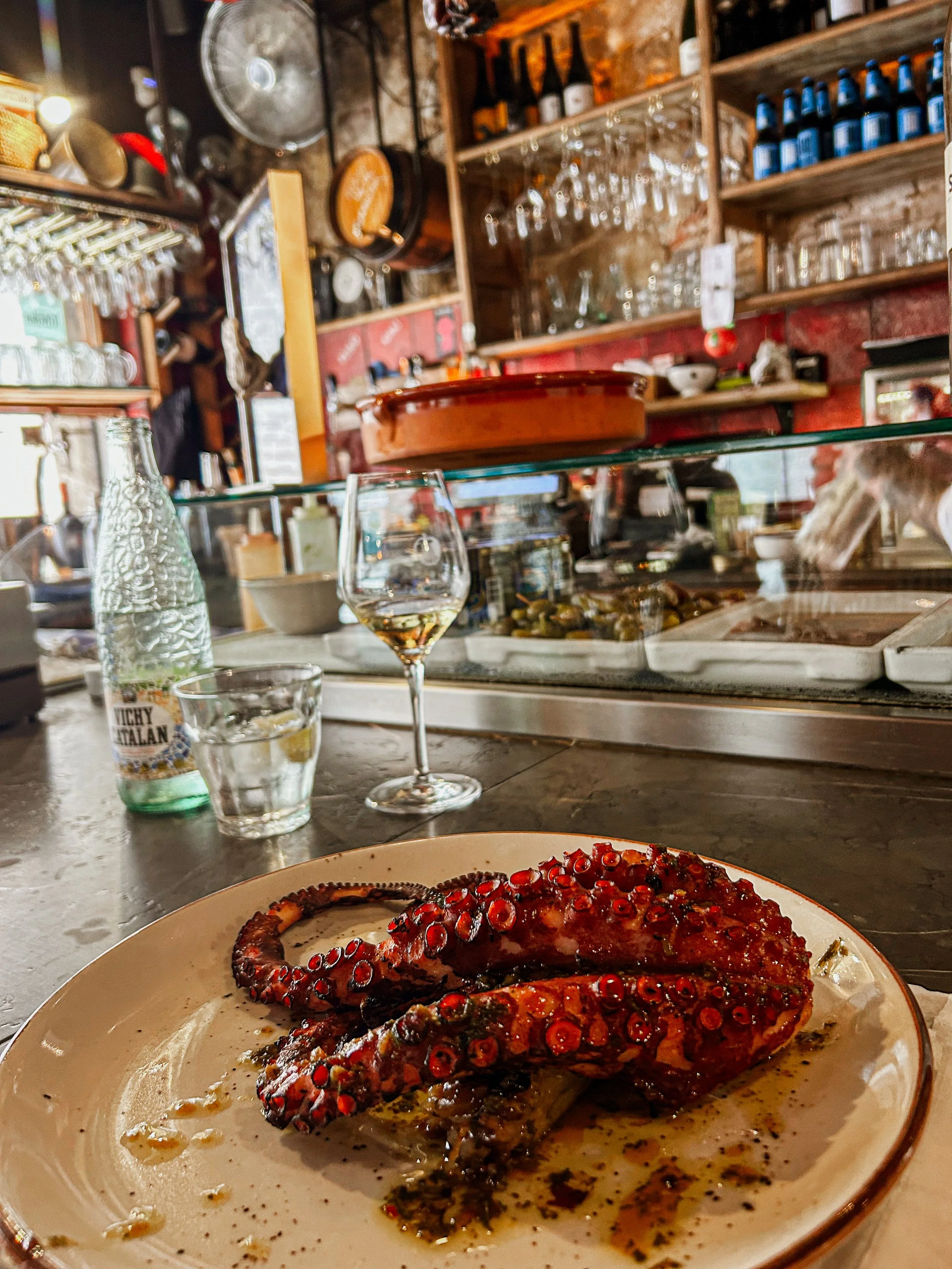 Grilled Octopus and a glass of white wine from a lunch counter at El Chigre in Barcelona