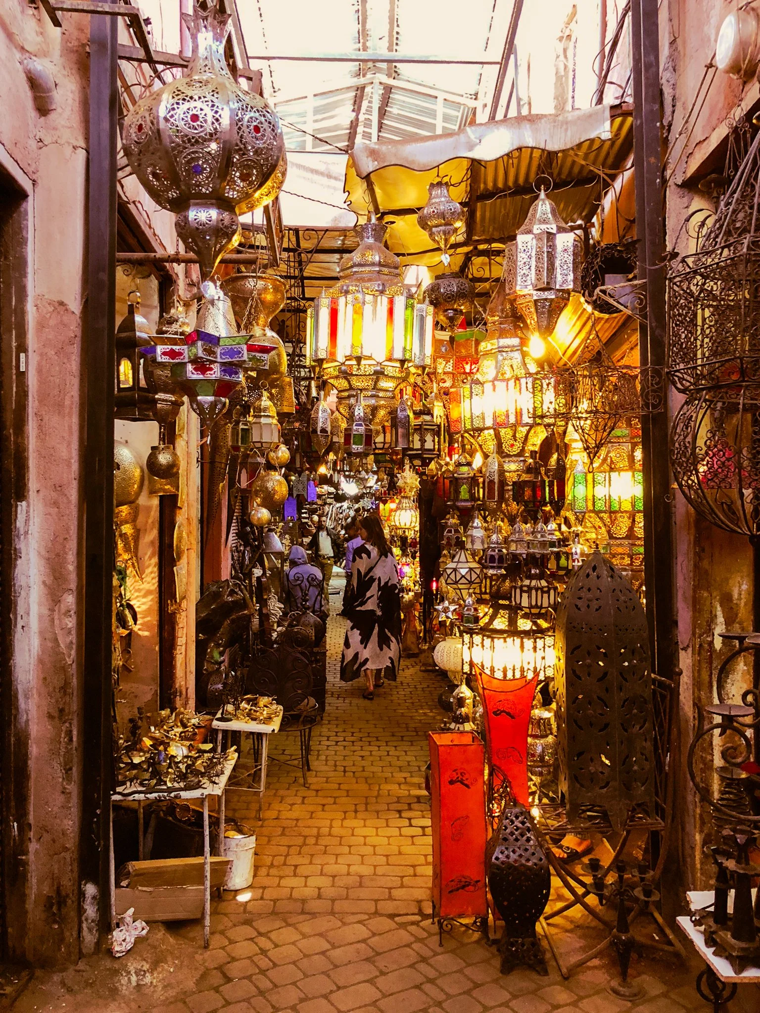 Busy, cluttered aisle of Marrakech Medina market