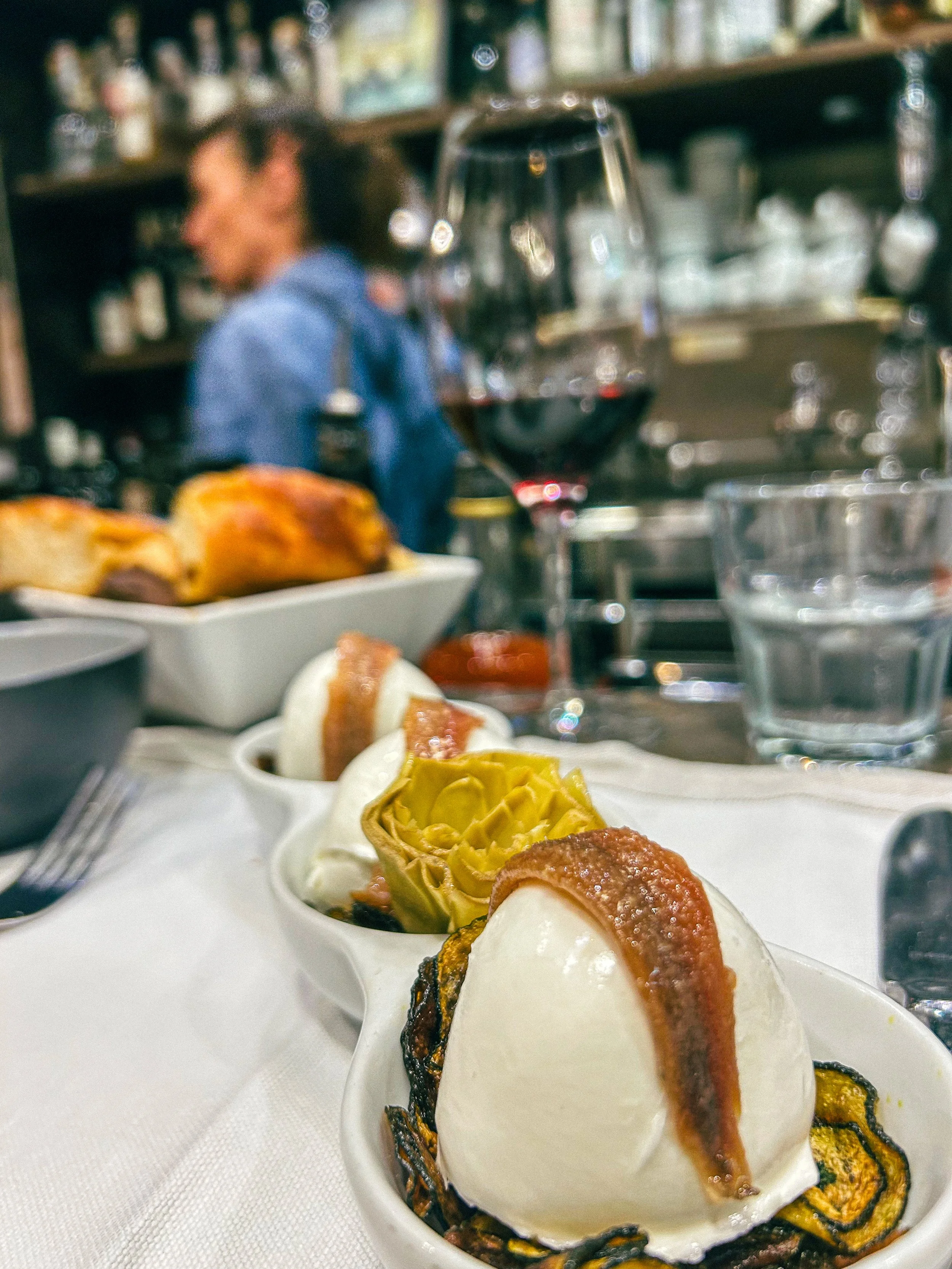 Anchovies draped over fresh burrata at Roscioli Salumeria in Rome, Italy