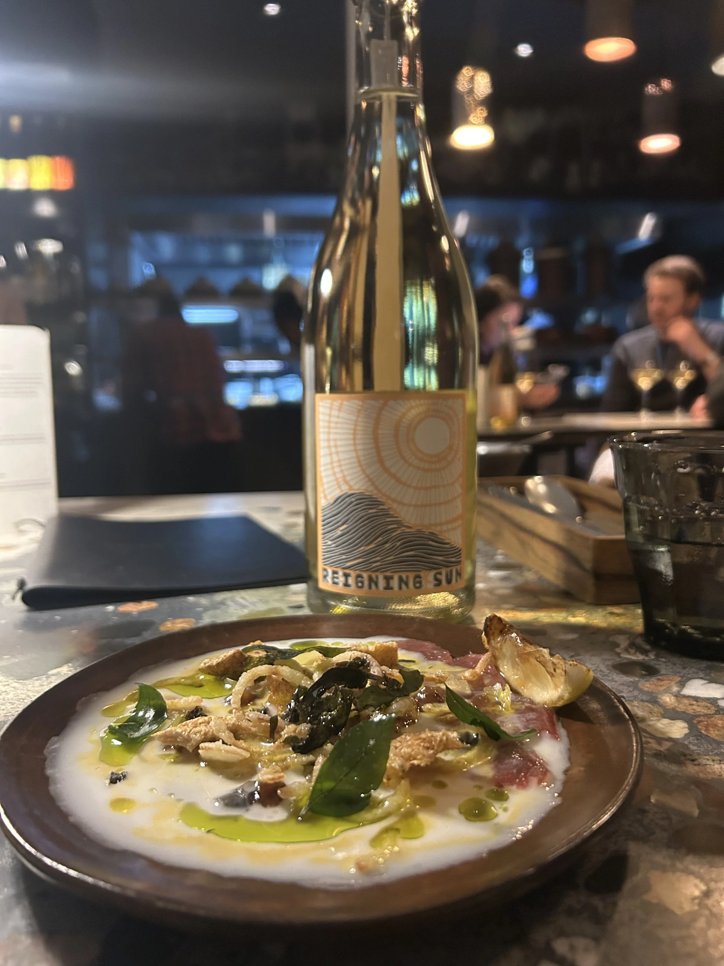 Bottle of Reigning Sun wine and food pairing at Seebamboes in Cape Town, South Africa