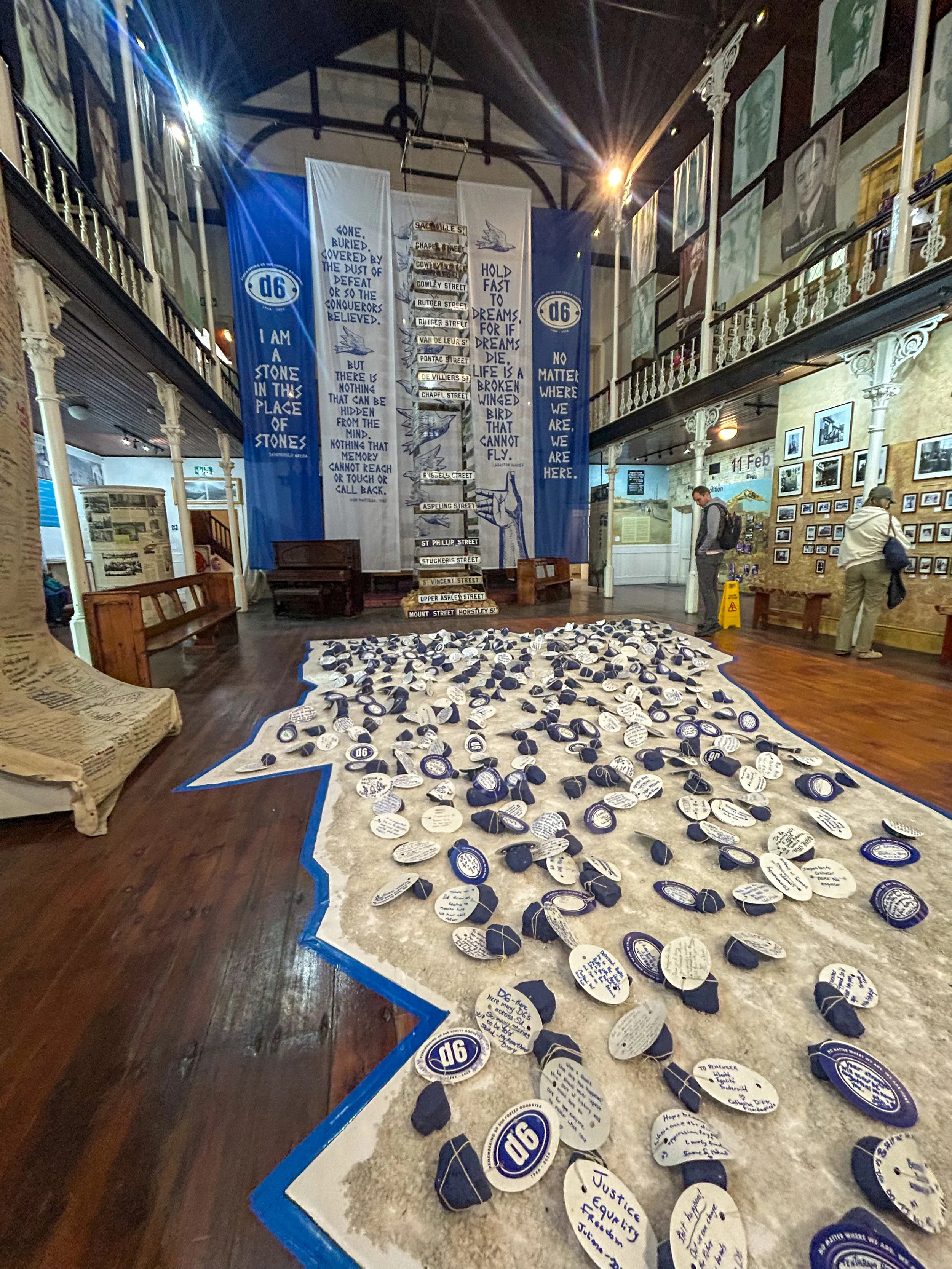 the inner atrium of the District Six Museum in Capetown South Africa, with notes pinned to the floor acting as a map of sorrow instead of map of the neighborhood