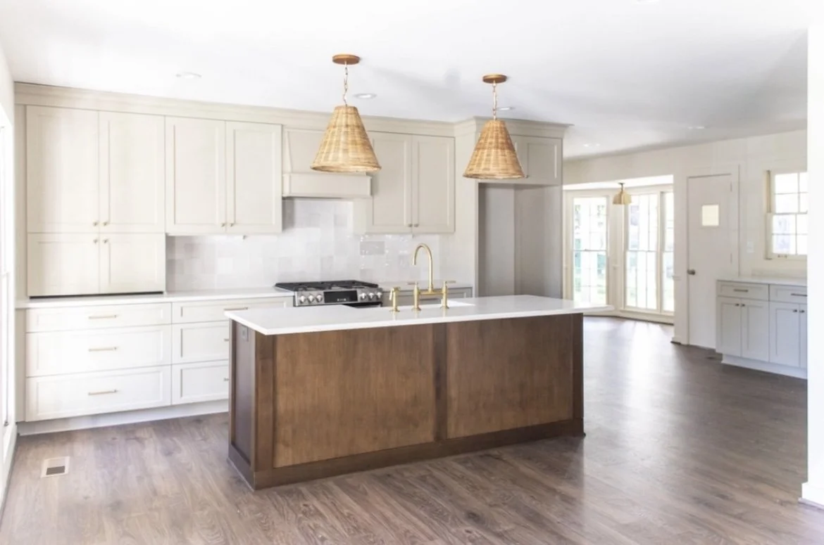 Modern kitchen with white cabinetry, wood island, and pendant lights