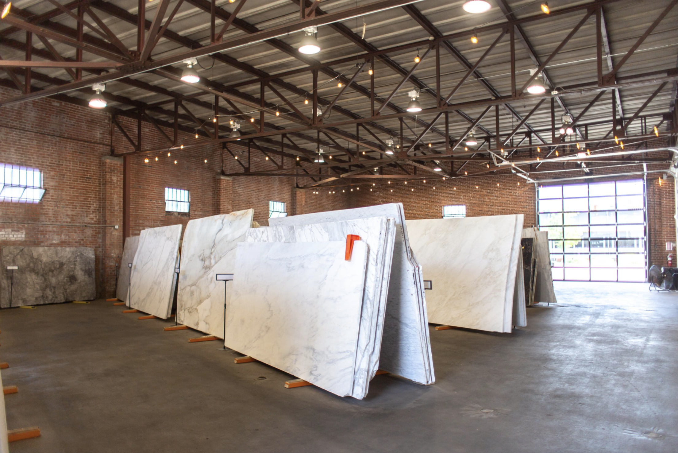 Interior of a warehouse with large marble slabs on display. Synergy Stone and Cottage Supply Company in Birmingham, AL