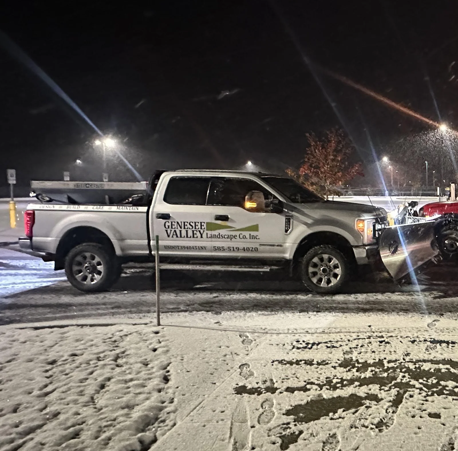 Genesee Valley plow truck and salt truck ready for overnight snow removal at a commercial lot in Livingston County, NY