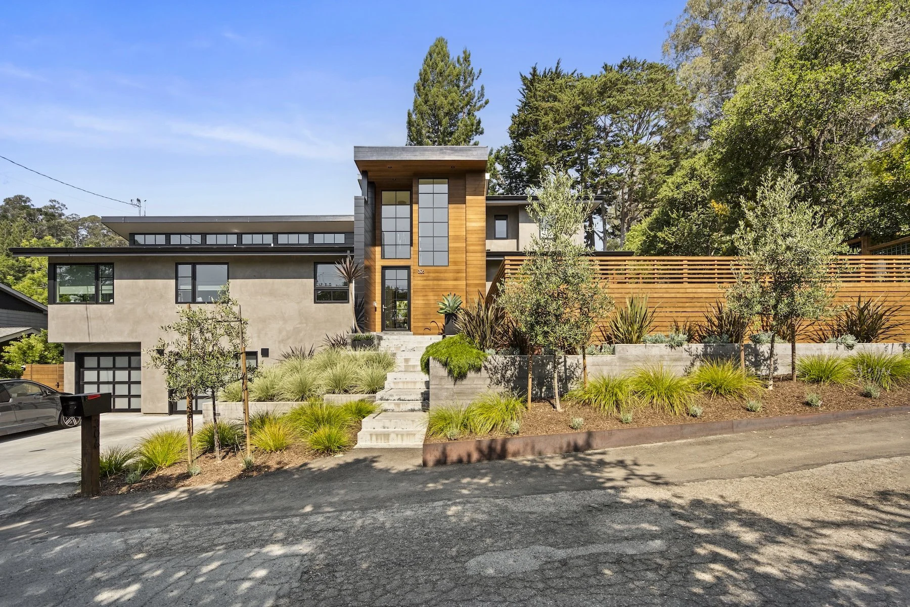 Front of modern home with retaianing walls and expert plantings