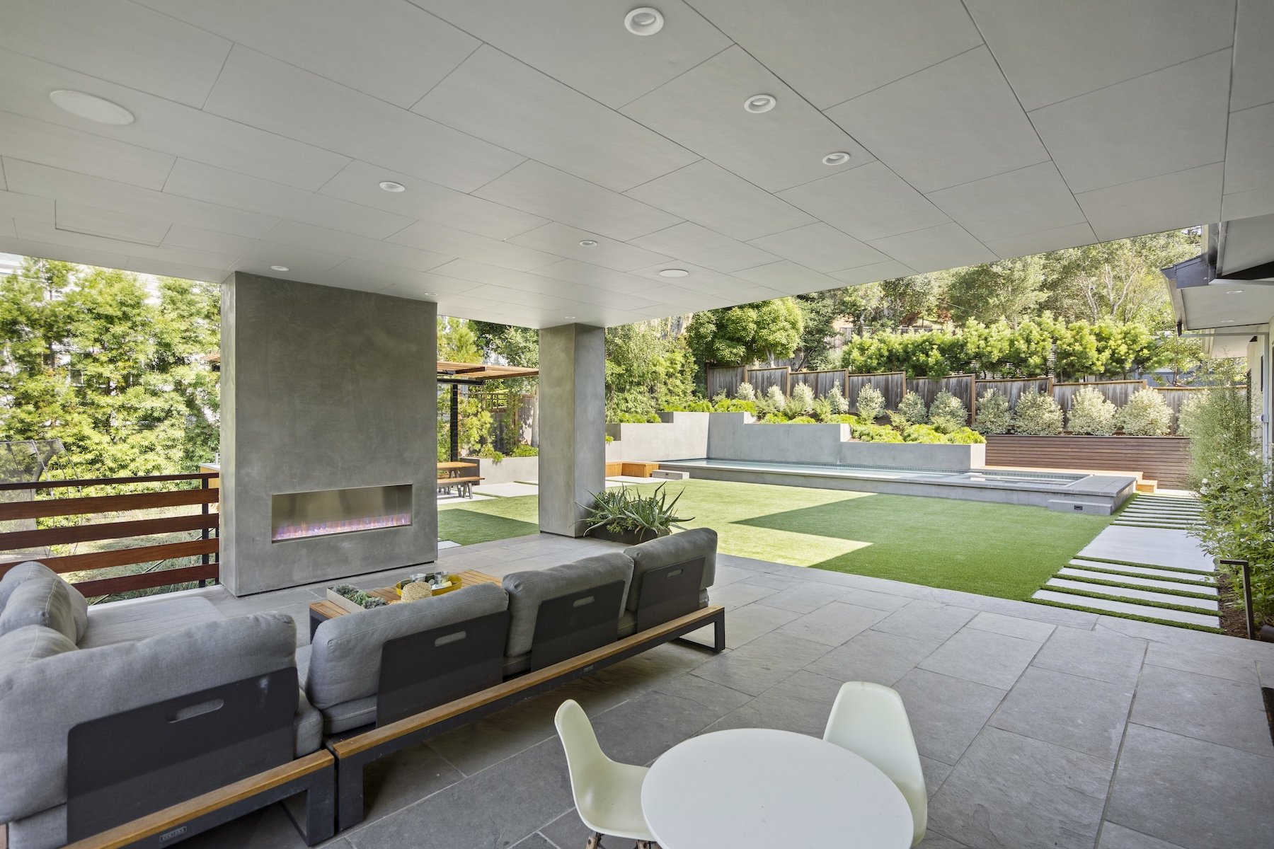 Modern, luxury outdoor fireplace and open-air seating area