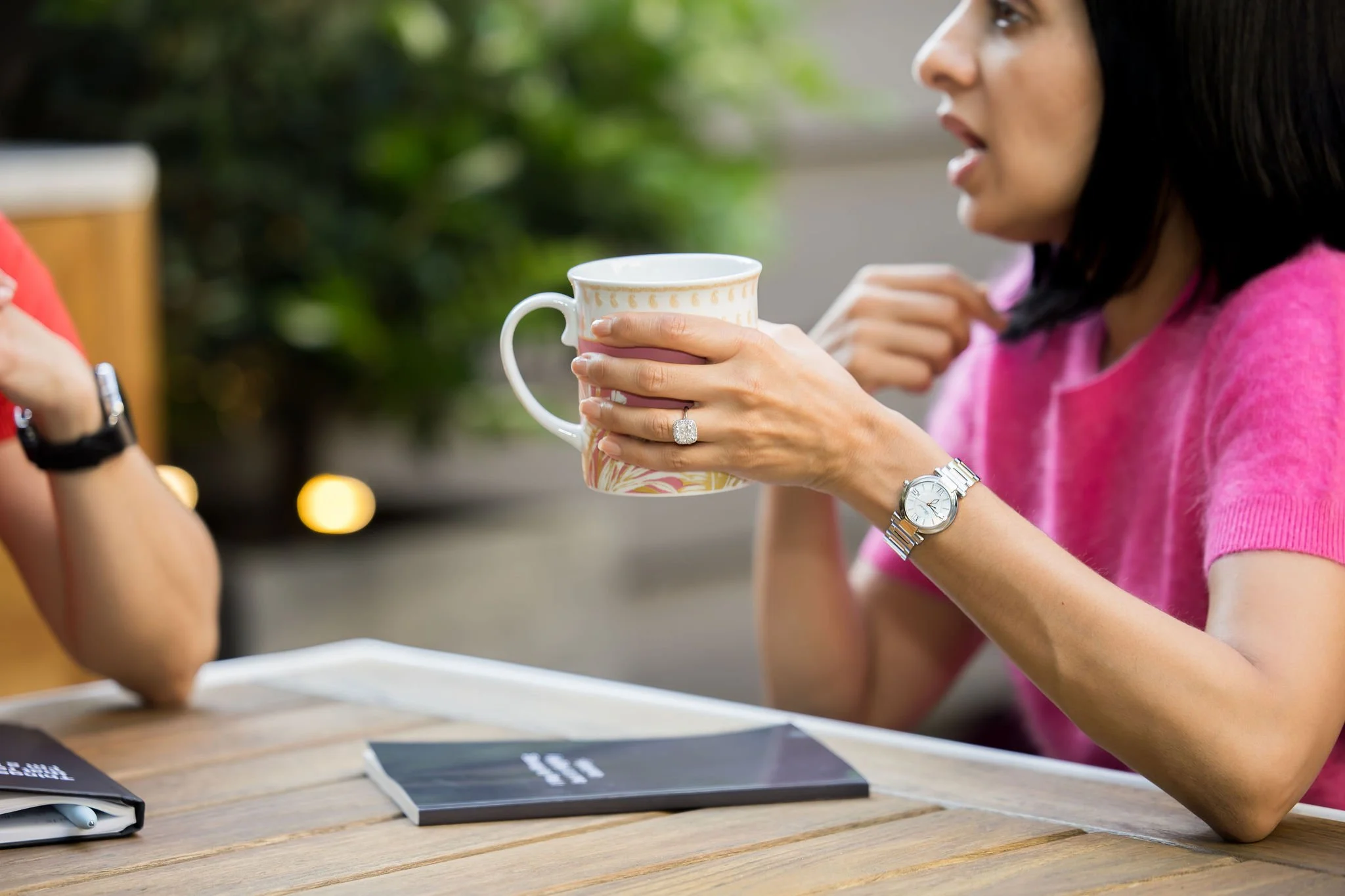Nicole and Priya in a one-on-one session drinking coffee and journaling