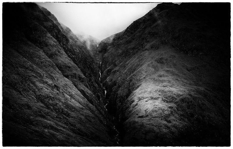 Photo by John Malley - "I stunning use of light really make this photo pop as a monochrome image, that light shaft on the sides of the waterfall create the perfect frame and the creative choice not to reveal the top of the surrounding mountains leave