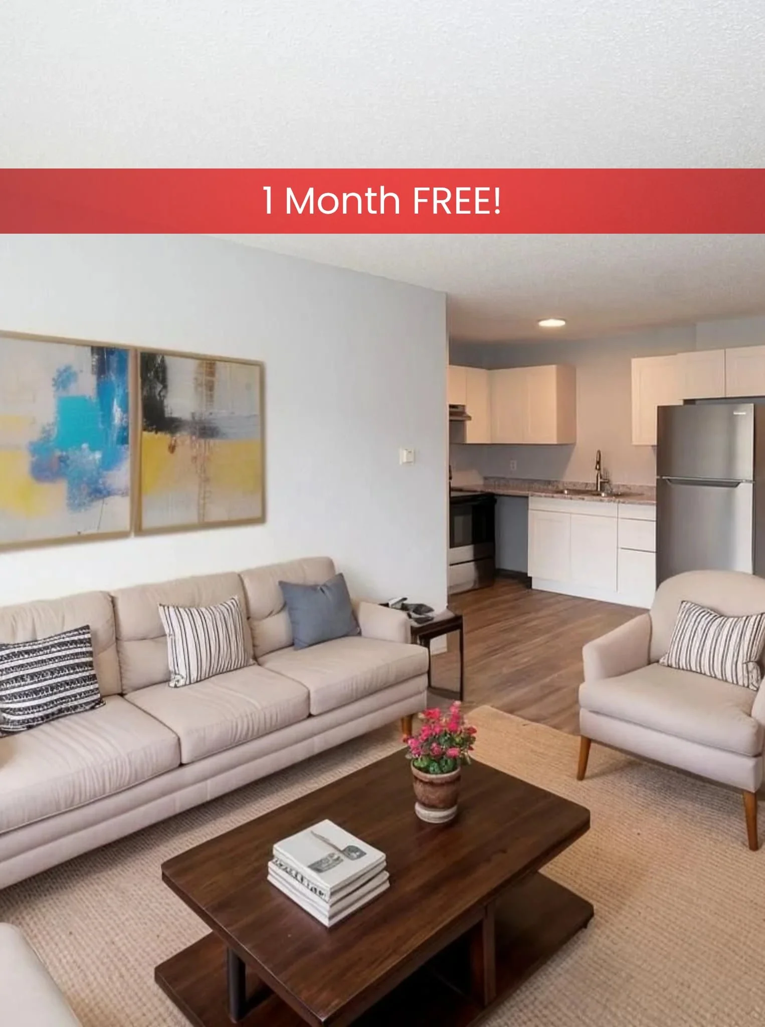 Modern living room in apartments in Rochester with beige couch, armchair, coffee table, TV, kitchen, and plant on wood flooring.
