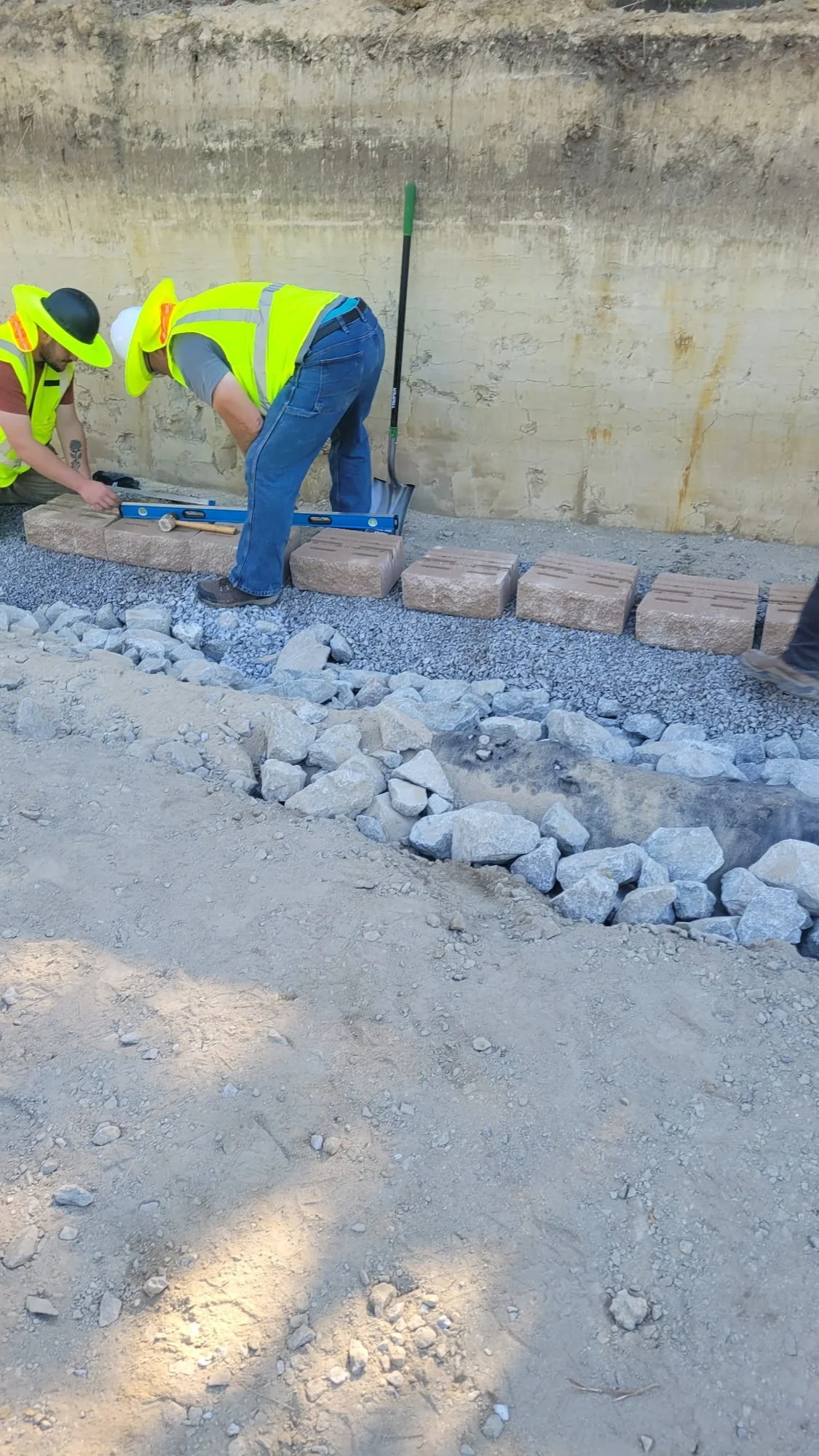Site Work: Permeable Paver Lot & Retaining Wall — wall backfill and stone placement, Hughes 360 Services