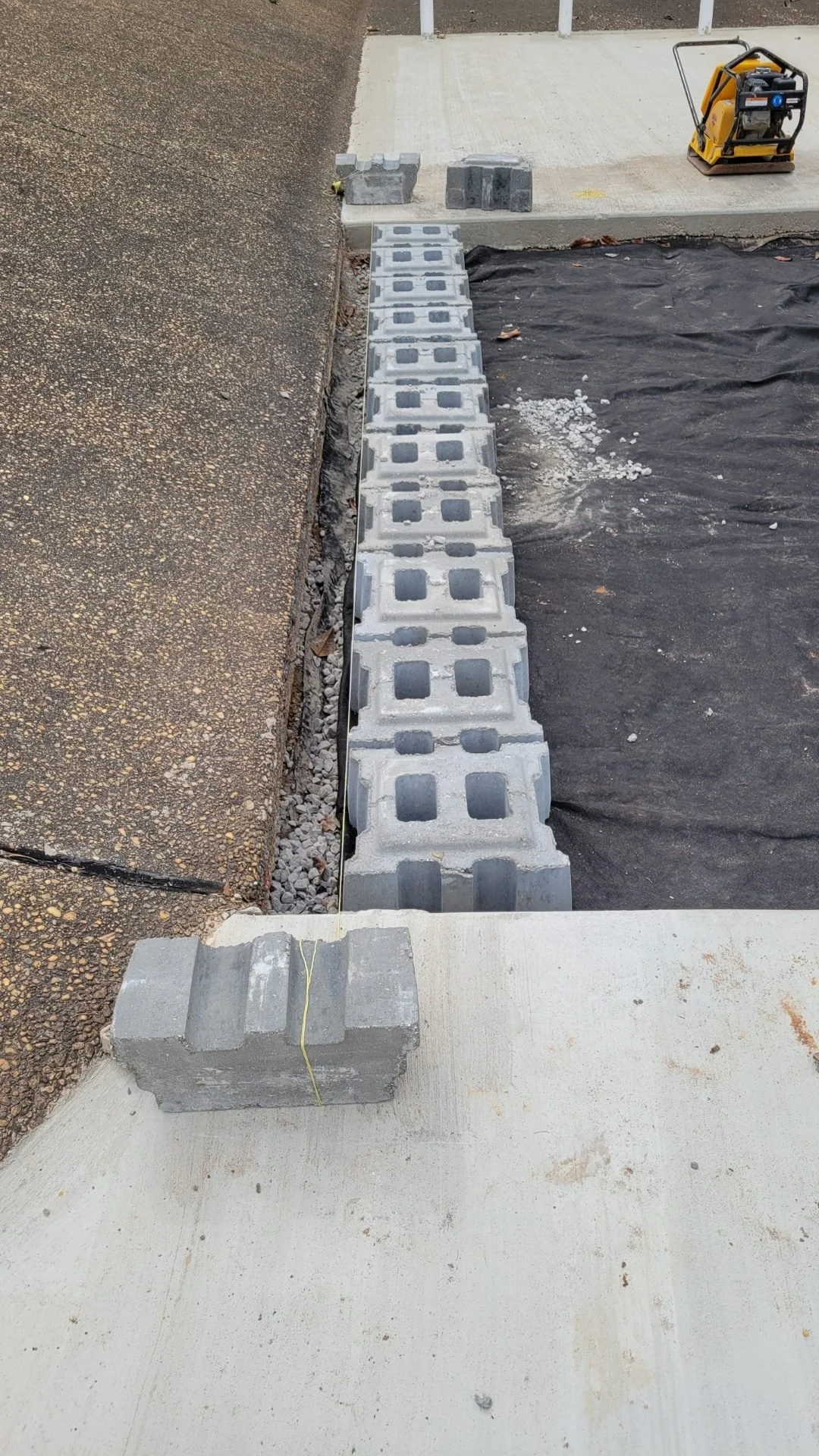 US Coast Guard Drainage Channel Repair — open-cell erosion control block being set, Hughes 360 Services