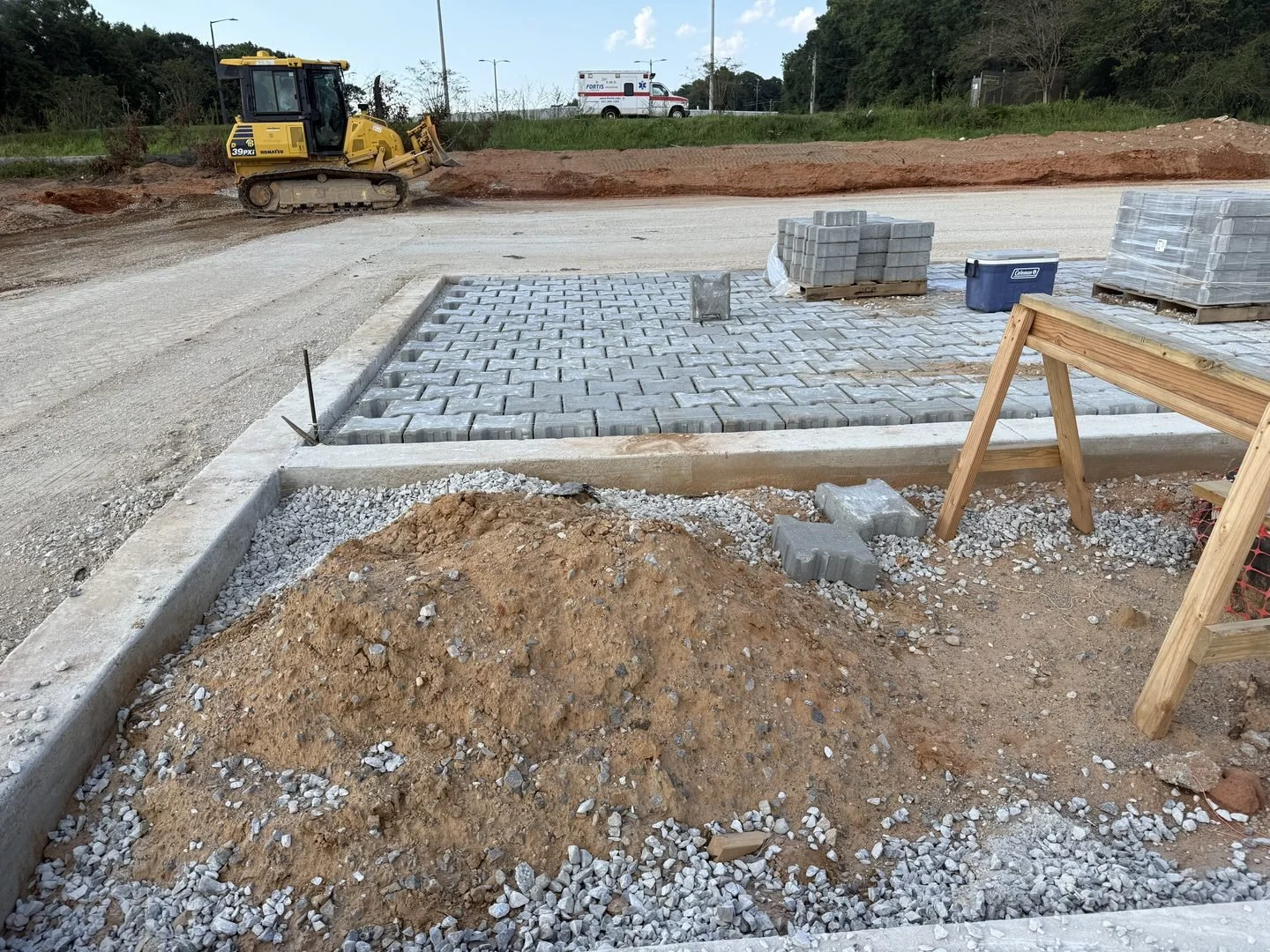 Site Work: Permeable Paver Lot & Retaining Wall — paver installation progressing across the lot, Hughes 360 Services