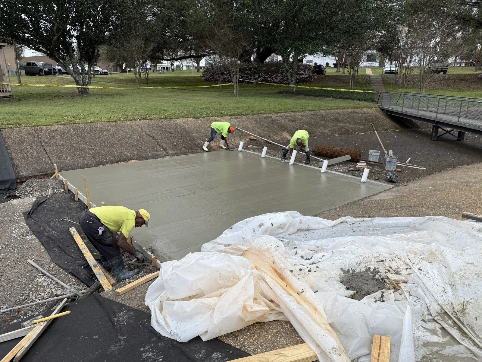 US Coast Guard Drainage Channel Repair — crew screeding the fresh concrete, Hughes 360 Services