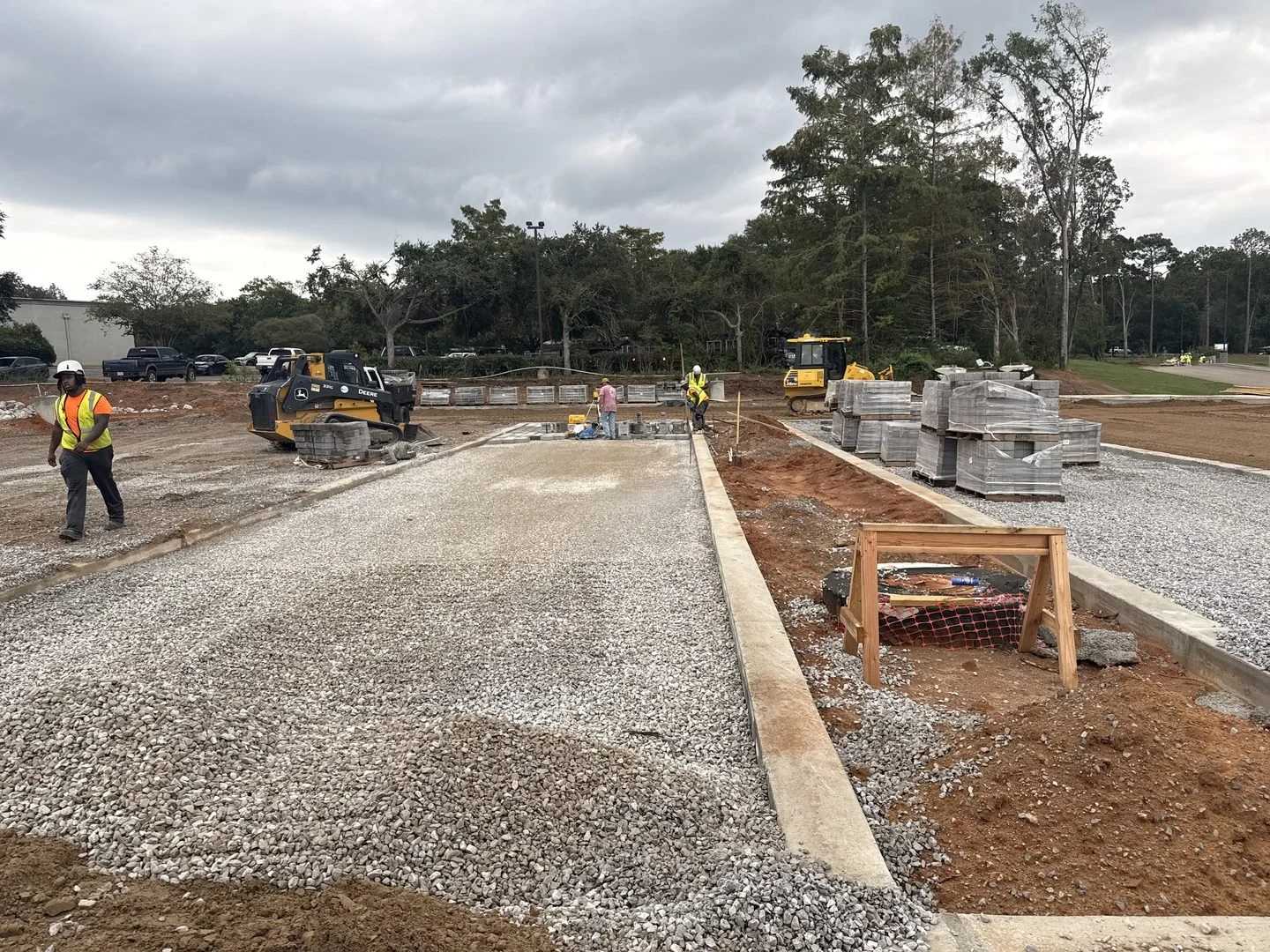 Site Work: Permeable Paver Lot & Retaining Wall — pavers being laid on the prepared base, Hughes 360 Services