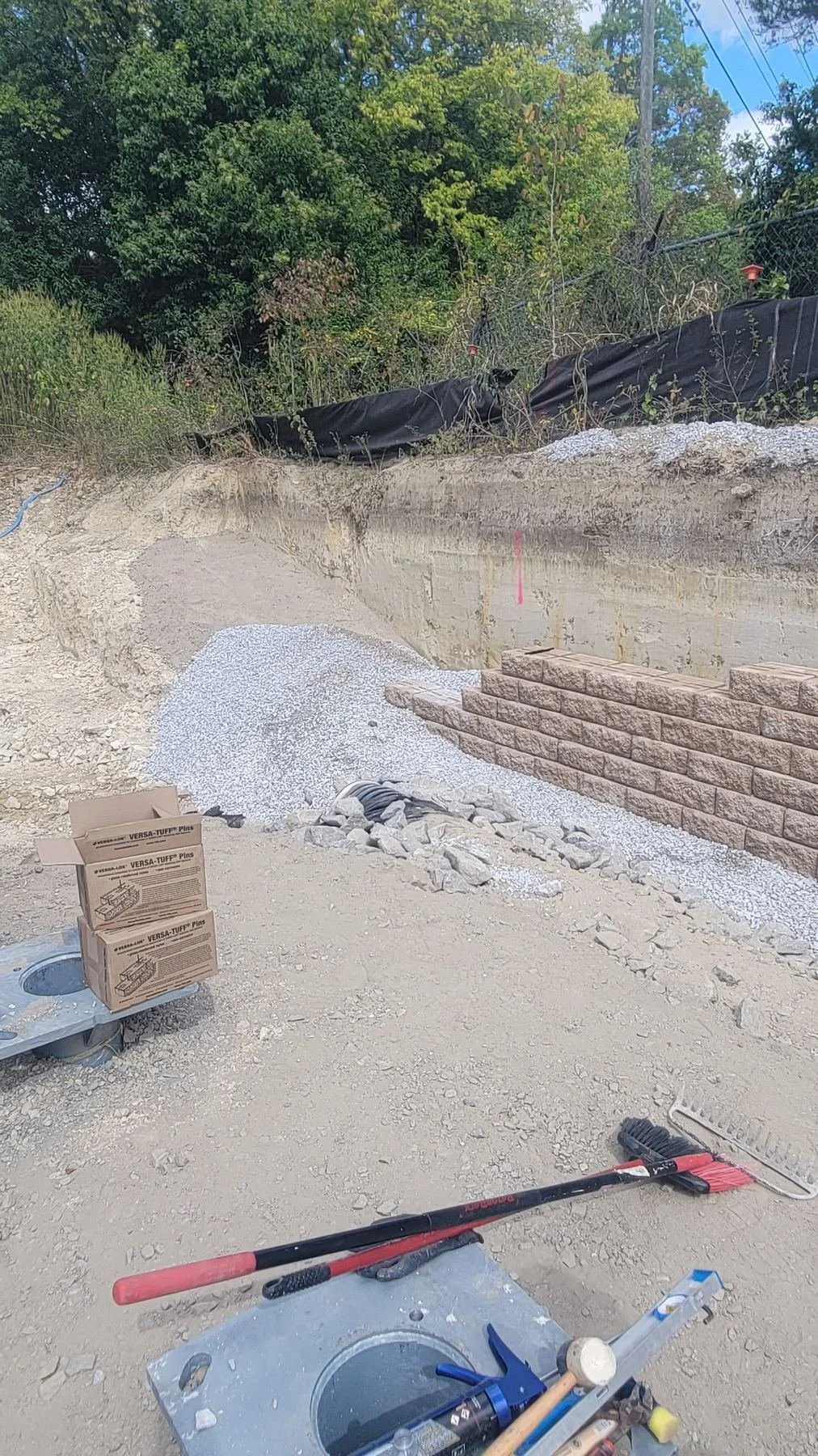 Site Work: Permeable Paver Lot & Retaining Wall — wall and drainage work in progress, Hughes 360 Services