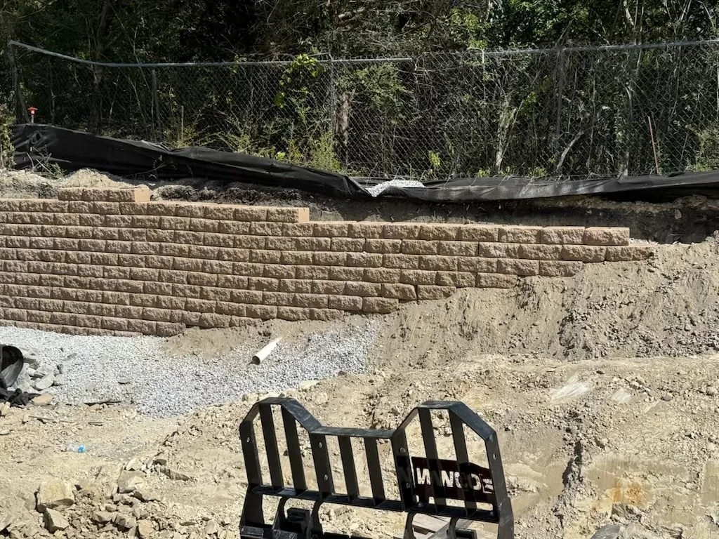Site Work: Permeable Paver Lot & Retaining Wall — completed segmental block retaining wall, Hughes 360 Services