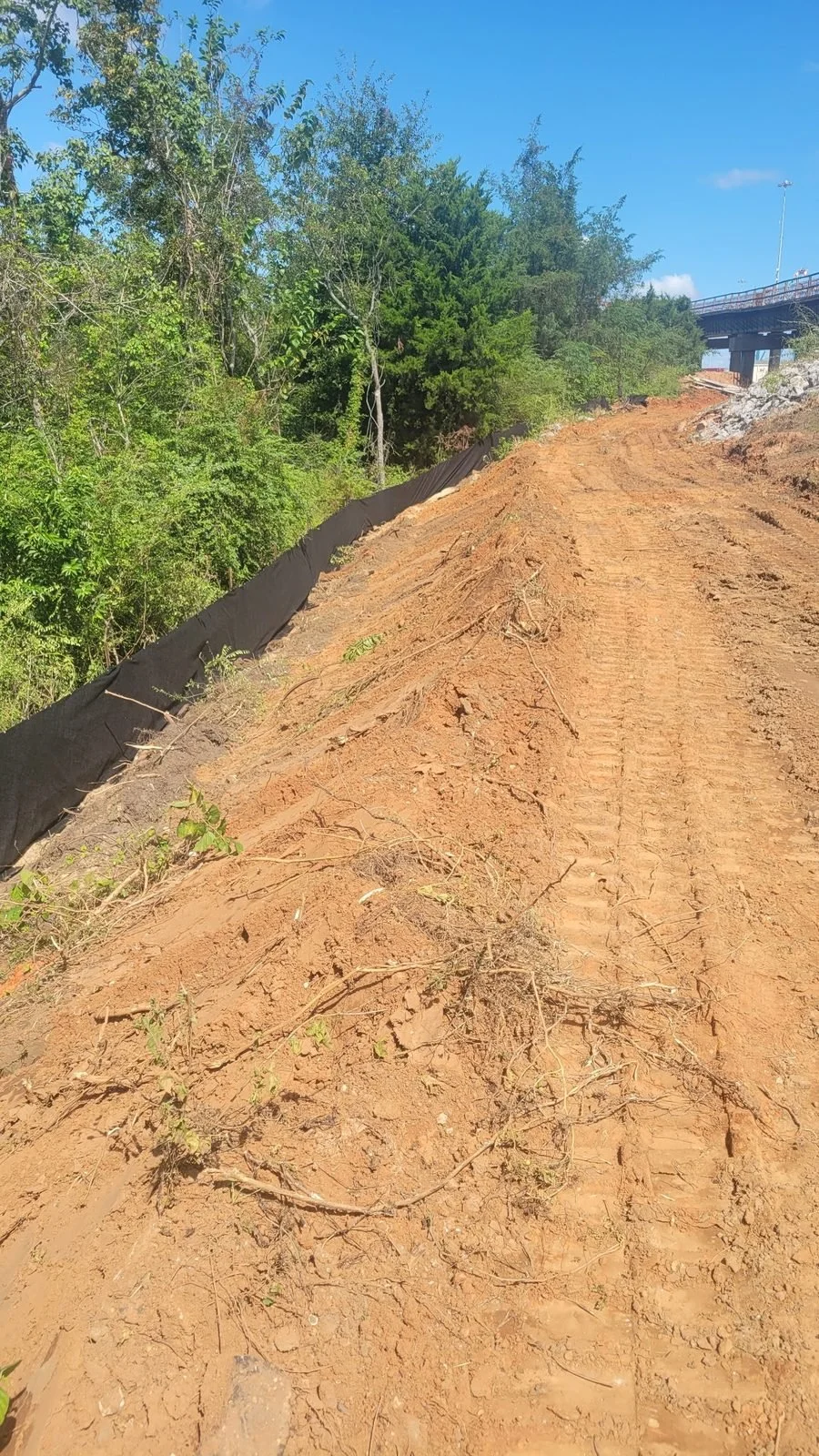 Erosion and sediment control, Mobile, AL — silt fence installed along the bank, Hughes 360 Services
