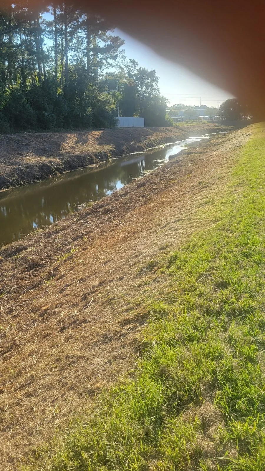 City of Mobile storm drainage ditch clearing — maintained canal bank after work, Hughes 360 Services