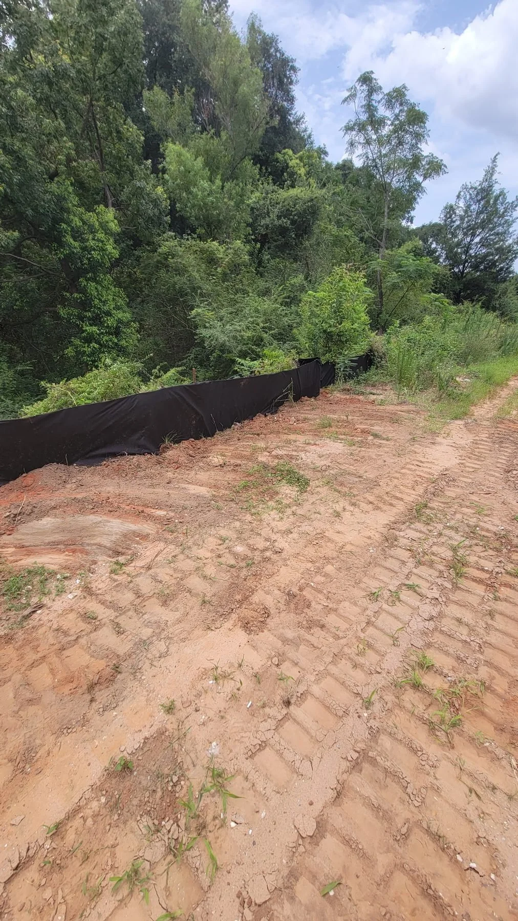 Erosion and sediment control, Mobile, AL — bank grading before armoring, Hughes 360 Services