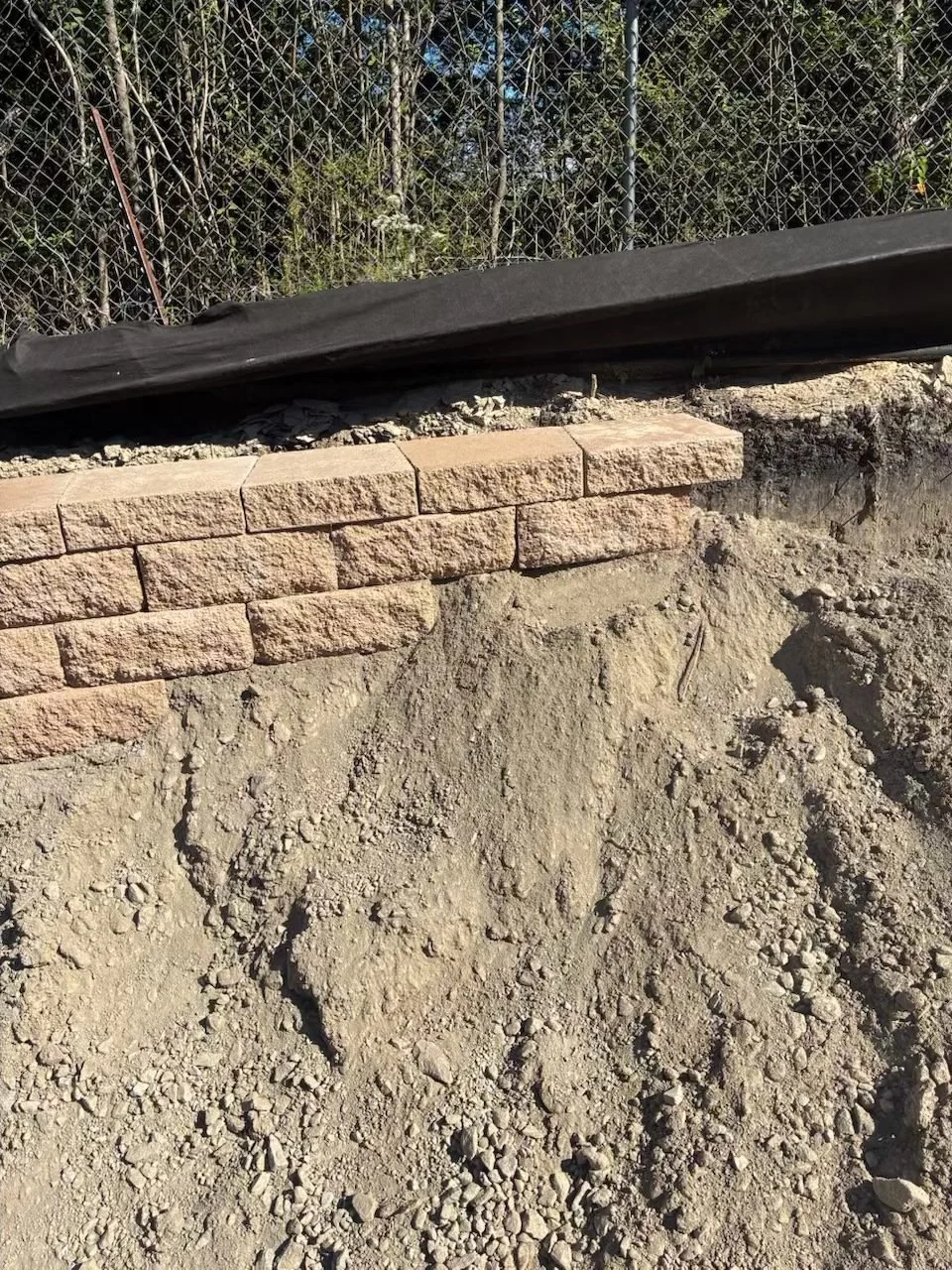 Site Work: Permeable Paver Lot & Retaining Wall — area inlet tied into the site drainage, Hughes 360 Services