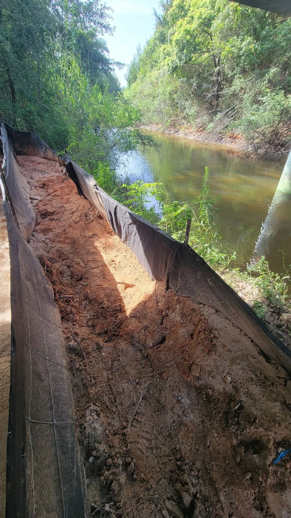 Erosion and sediment control, Mobile, AL — erosion control matting set on the slope, Hughes 360 Services
