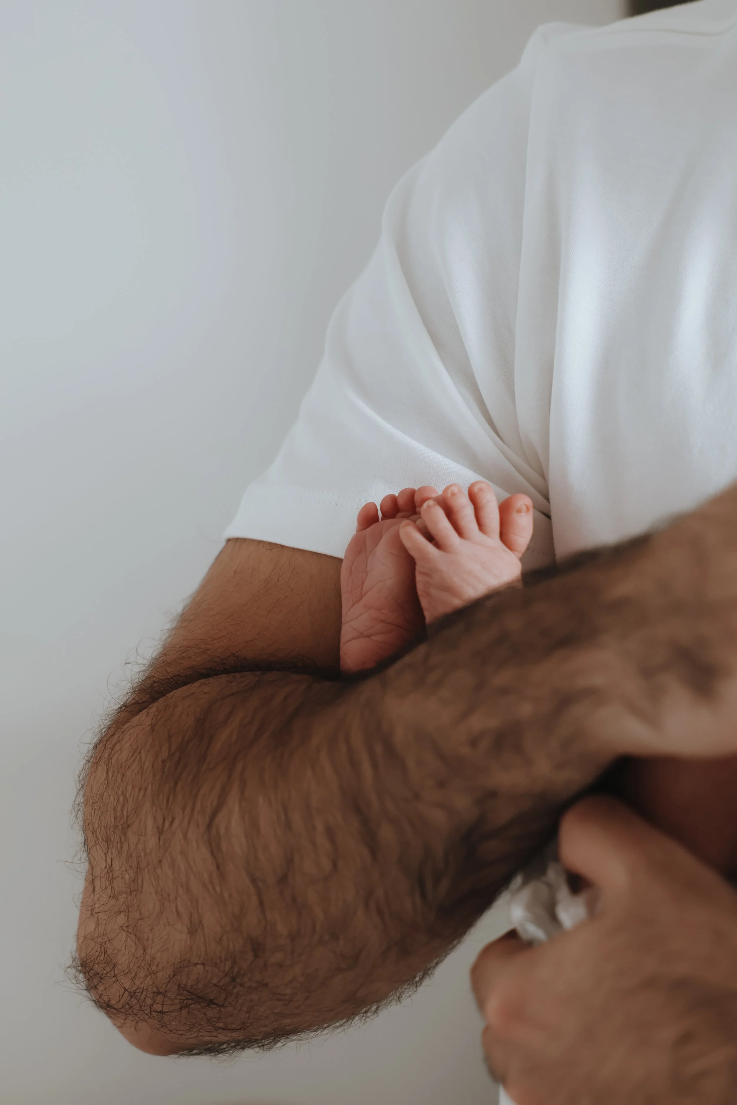 A newborn baby holding onto an adult's arm with both hands.  newborn details, newborn photography, bournemouth 