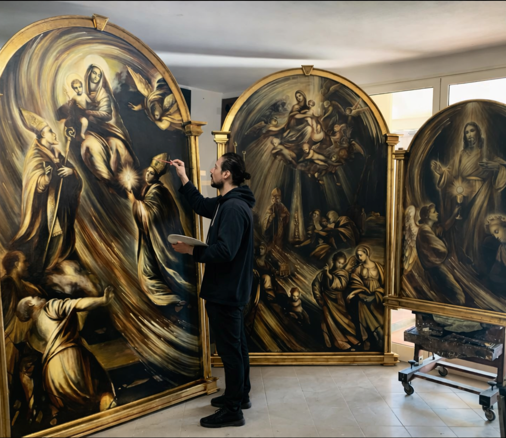An artist is working on a large religious painting, depicting scenes with angels and saints, using a brush and palette in a room with windows.