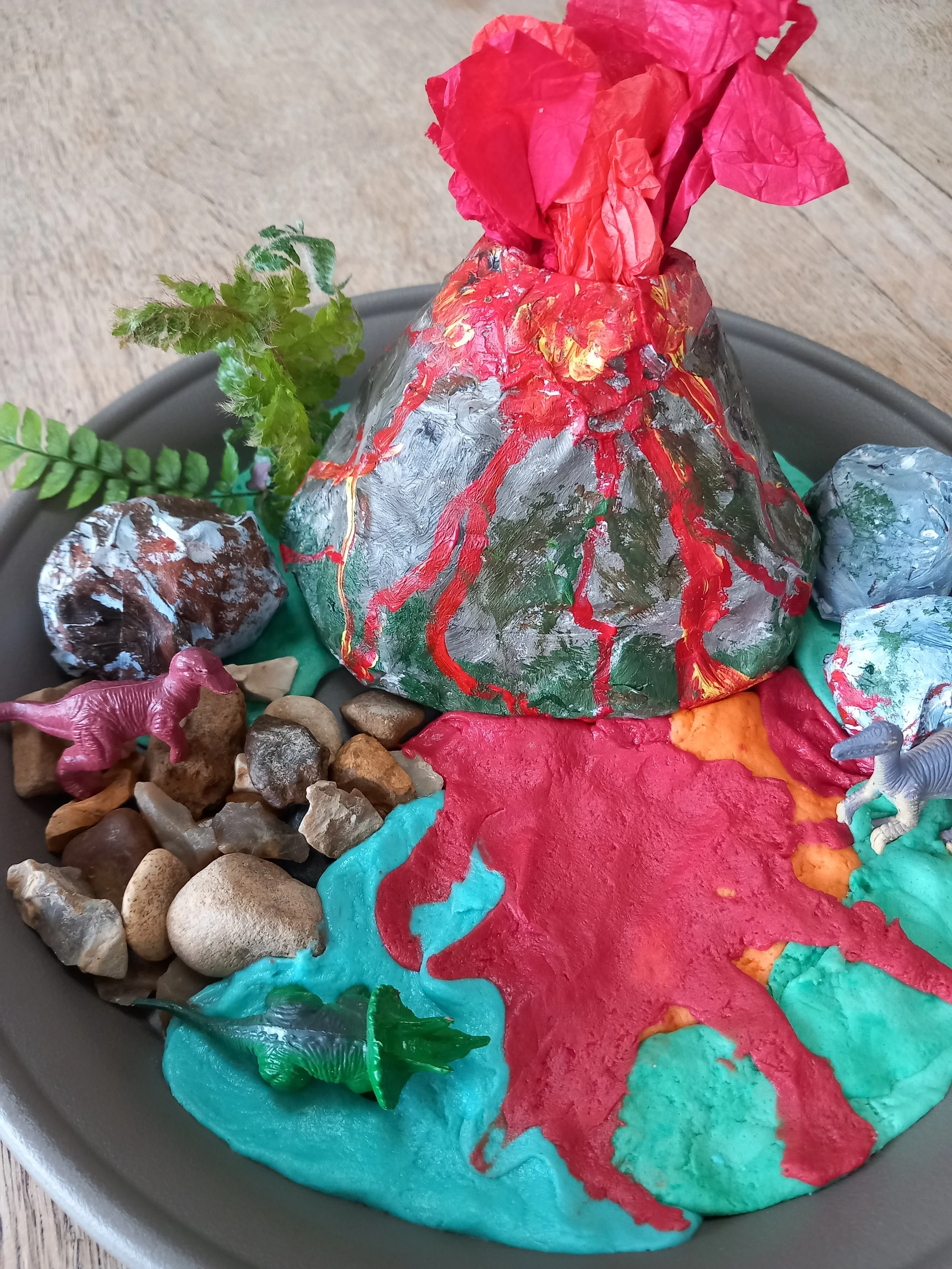Volcano dinosaurs

Build a prehistoric scene complete with exploding volcano, ash, boulders and trees.

Materials: recycled plastic plant saucer, newspaper, tissue paper, acrylic paint,  plastic dinosaurs, cardboard, pva glue, homemade play dough.