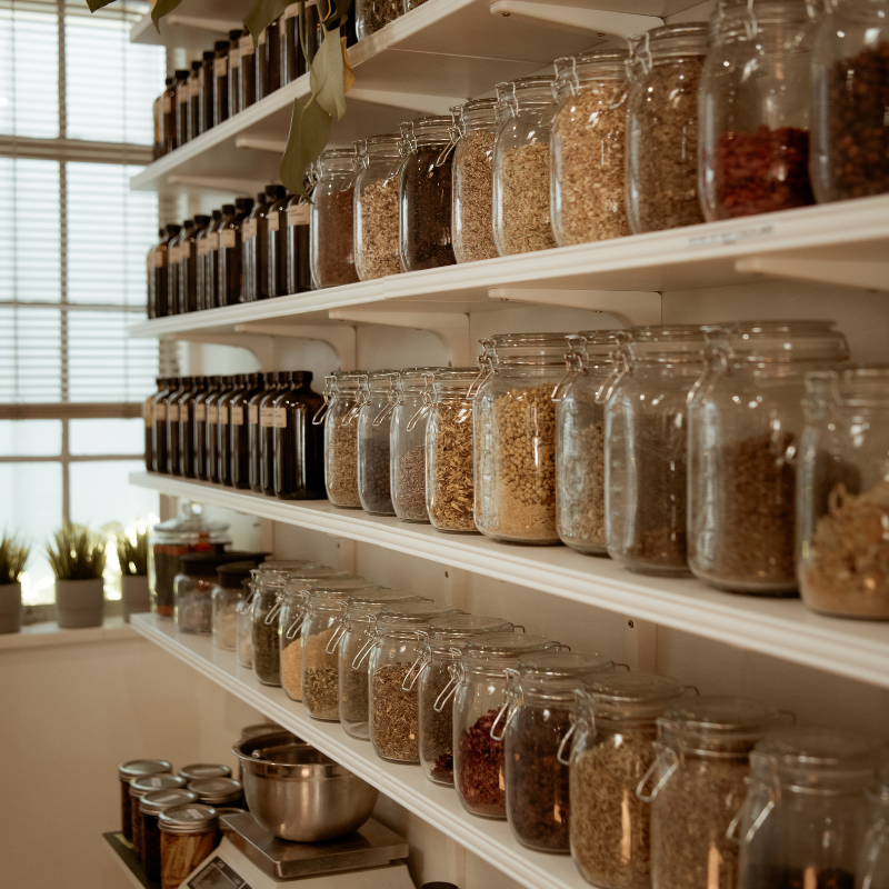 Person holding a bundle of dried herbs.