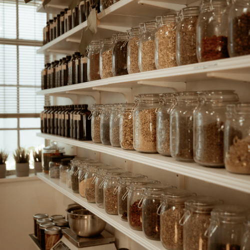 Person holding a bundle of dried herbs.