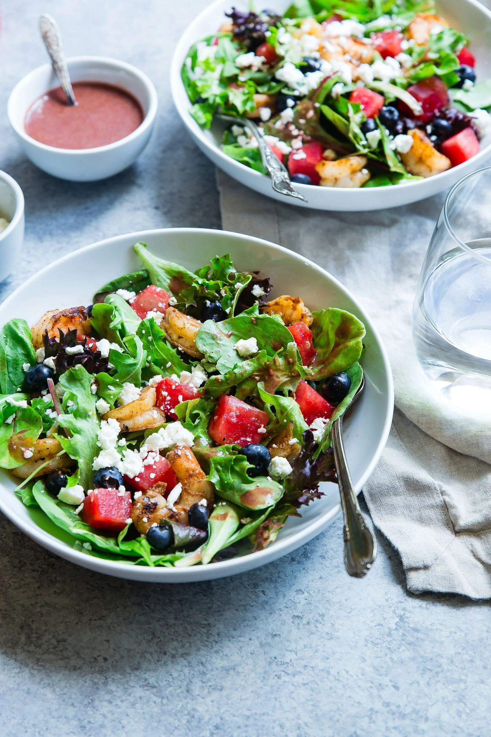 fresh healthy salad bowls on a grey granite background