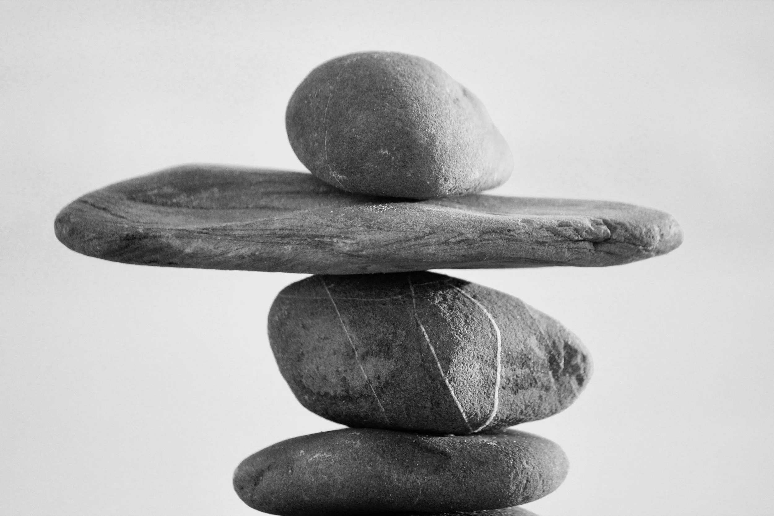 Grey stones balanced on top of each other kath samuels nutritional therapy