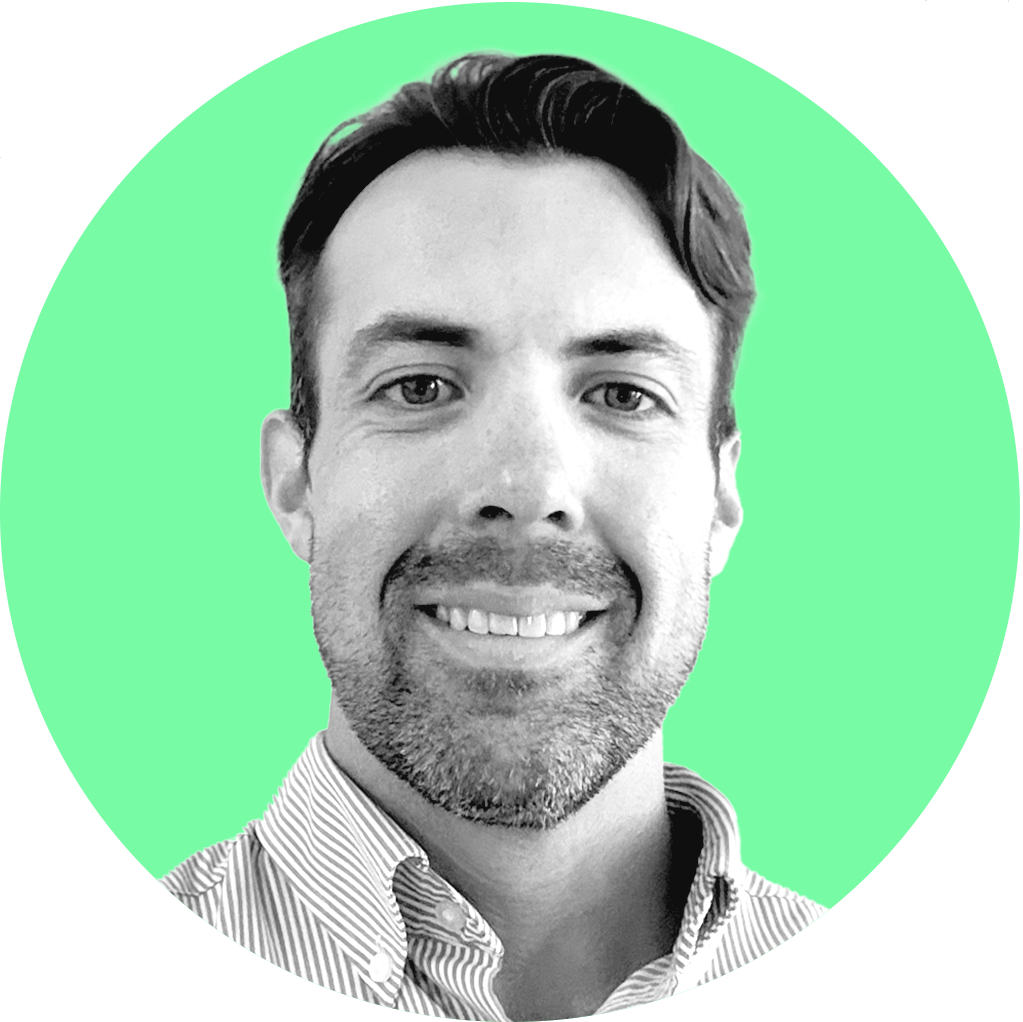 Black and white portrait of a smiling man with short dark hair, light stubble, wearing a collared shirt, set against a green background with a black curved shape in the upper left corner.