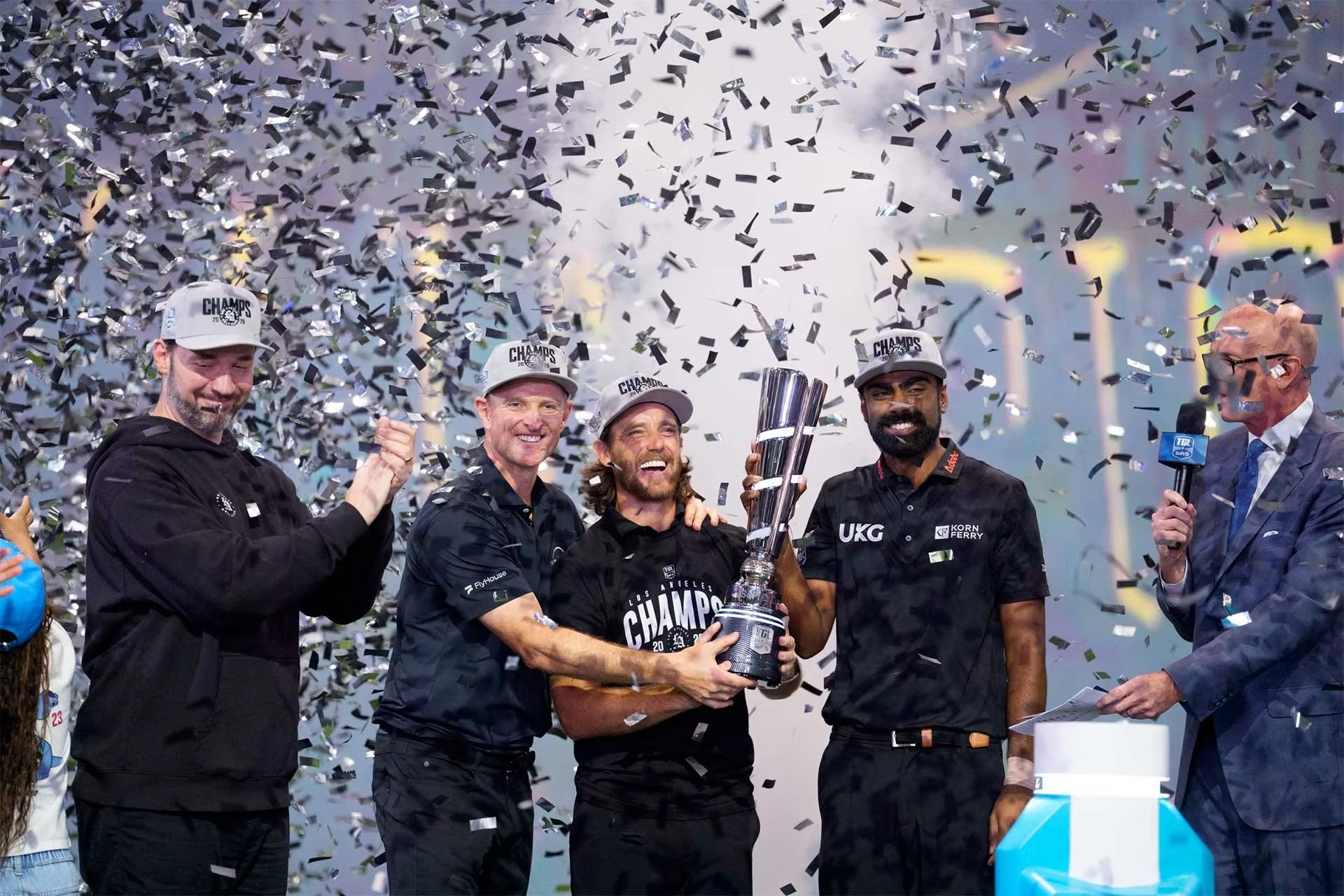 The Los Angeles GC team of Justin Rose, Tommy Fleetwood and Sahith Theegala celebrate after receiving the SoFi Cup (Photo: TGL)