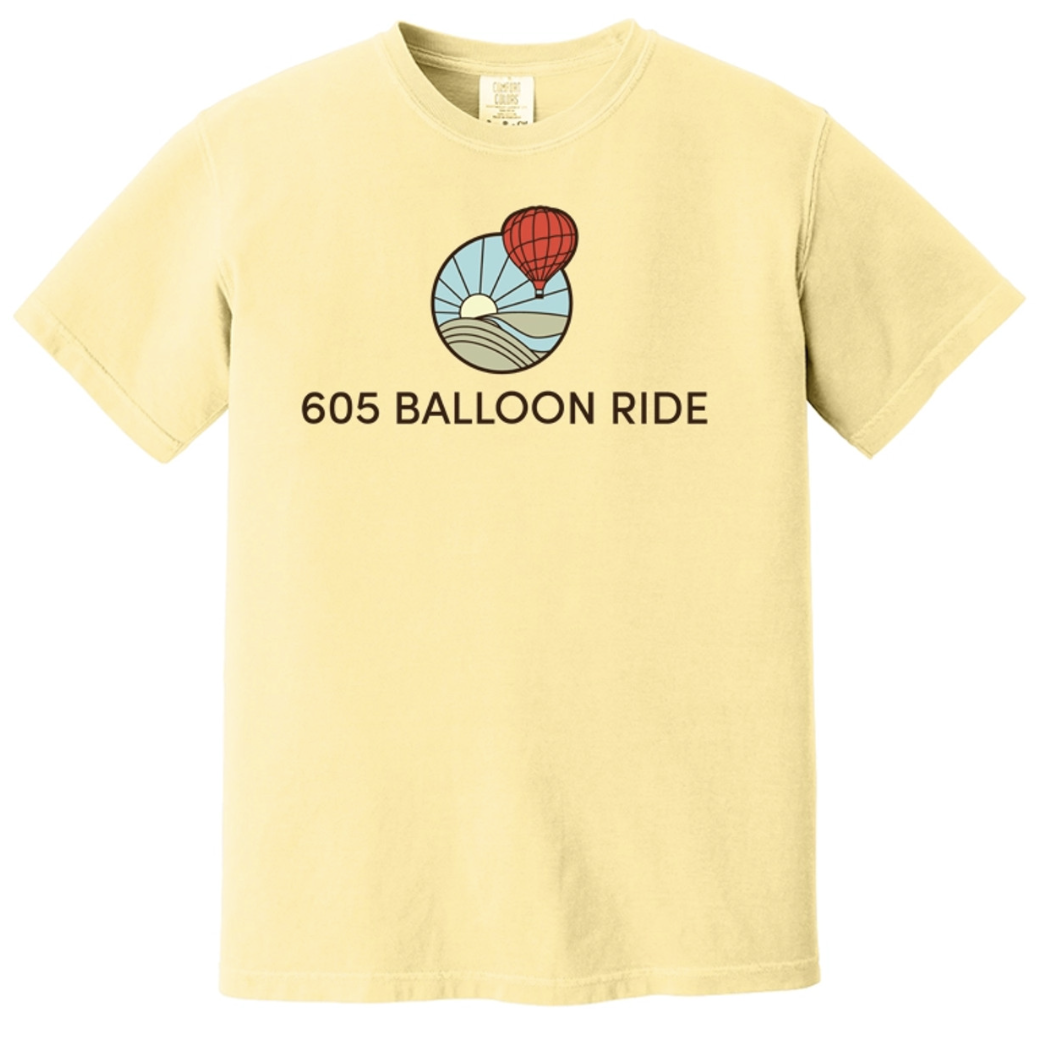 Yellow T-shirt with a graphic of a hot air balloon, a sun, and landscape, and the text "605 BALLOON RIDE" below the graphic.