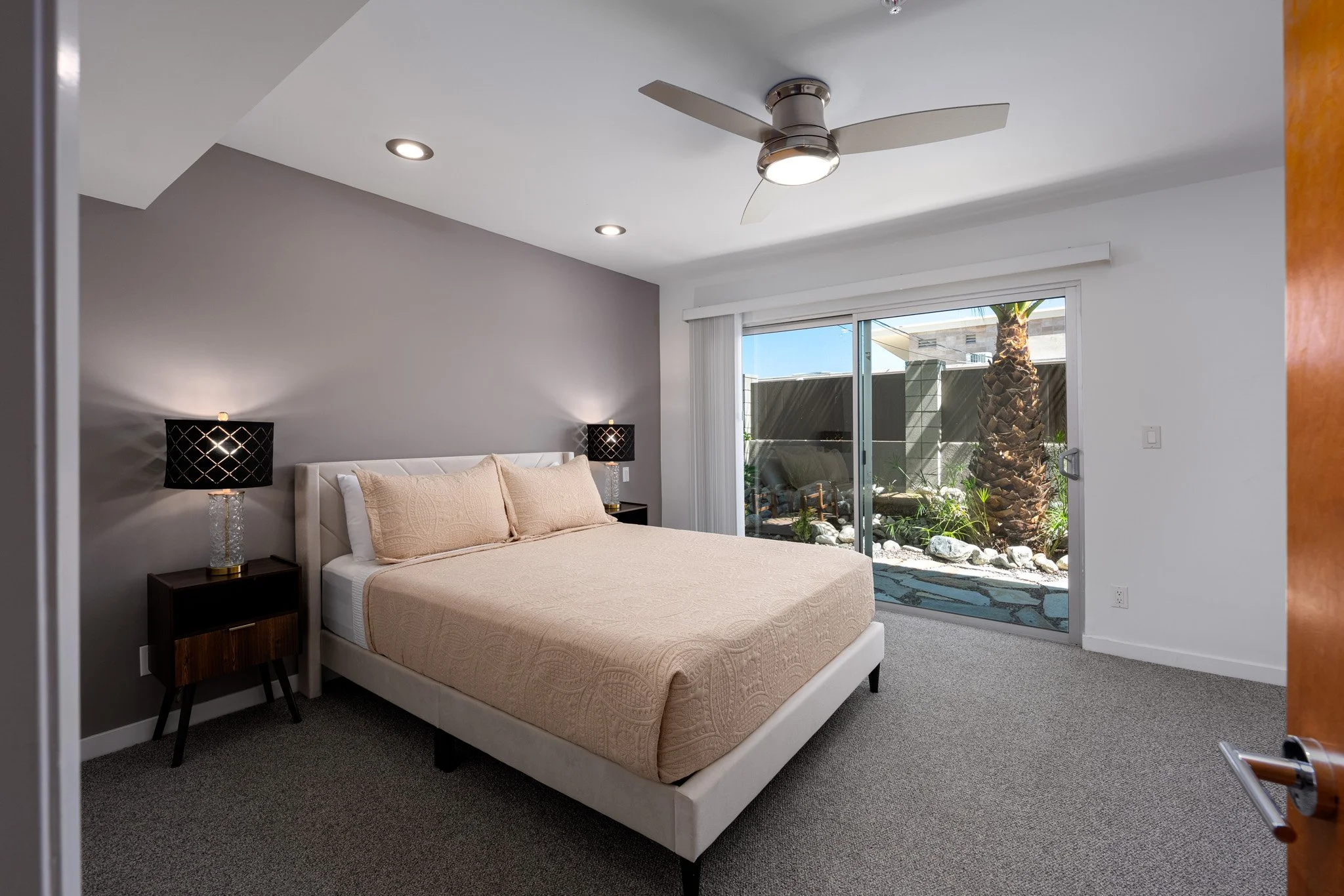 16 querencia-palms-unit-104-primary-bedroom-sliding-doors-to-patio.jpg