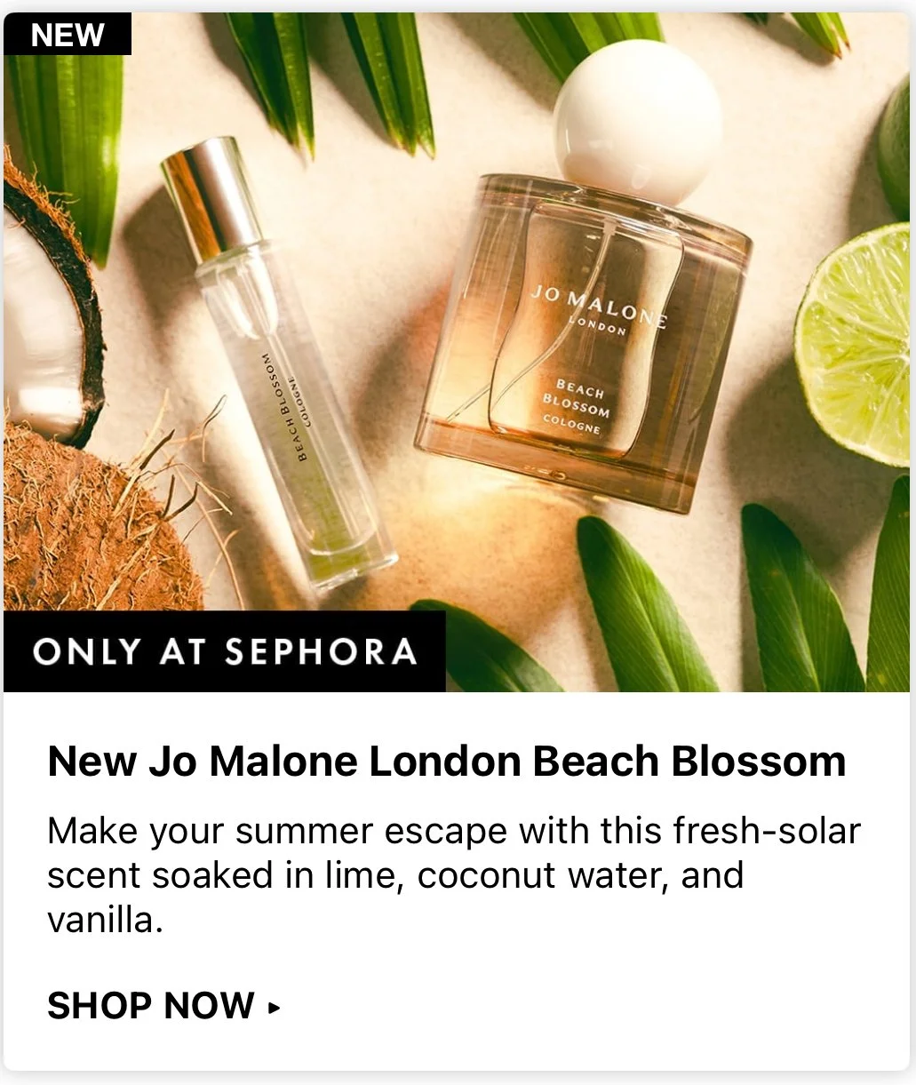 Jo Malone London Beach Blossom cologne bottle, a small perfume spray bottle, coconut, lime slice, green leaves, and a white ball