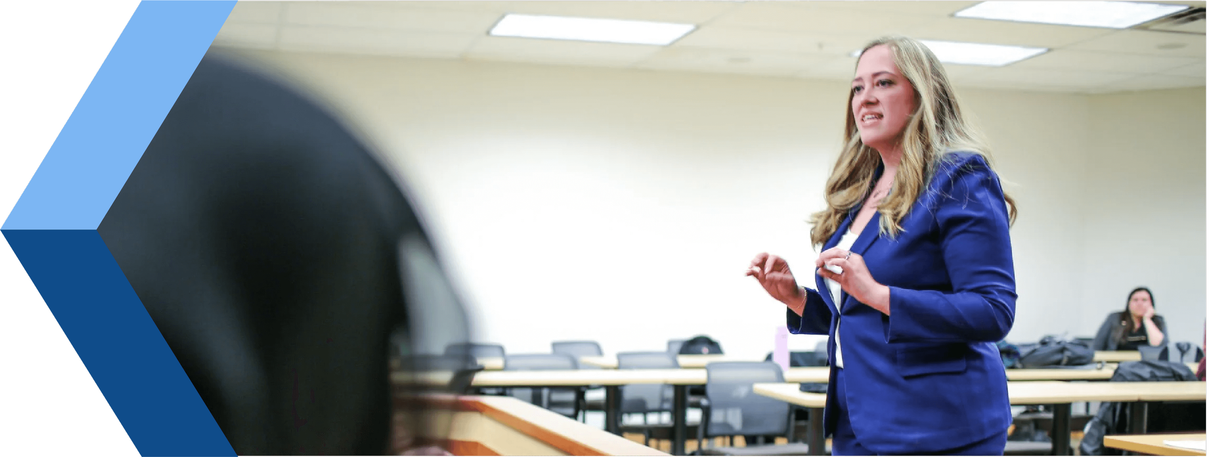Christina in a blue blazer speaking