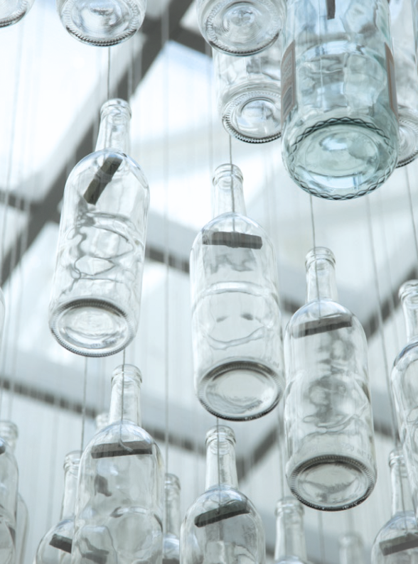 En masse bottles were hung with cut dowel and string.