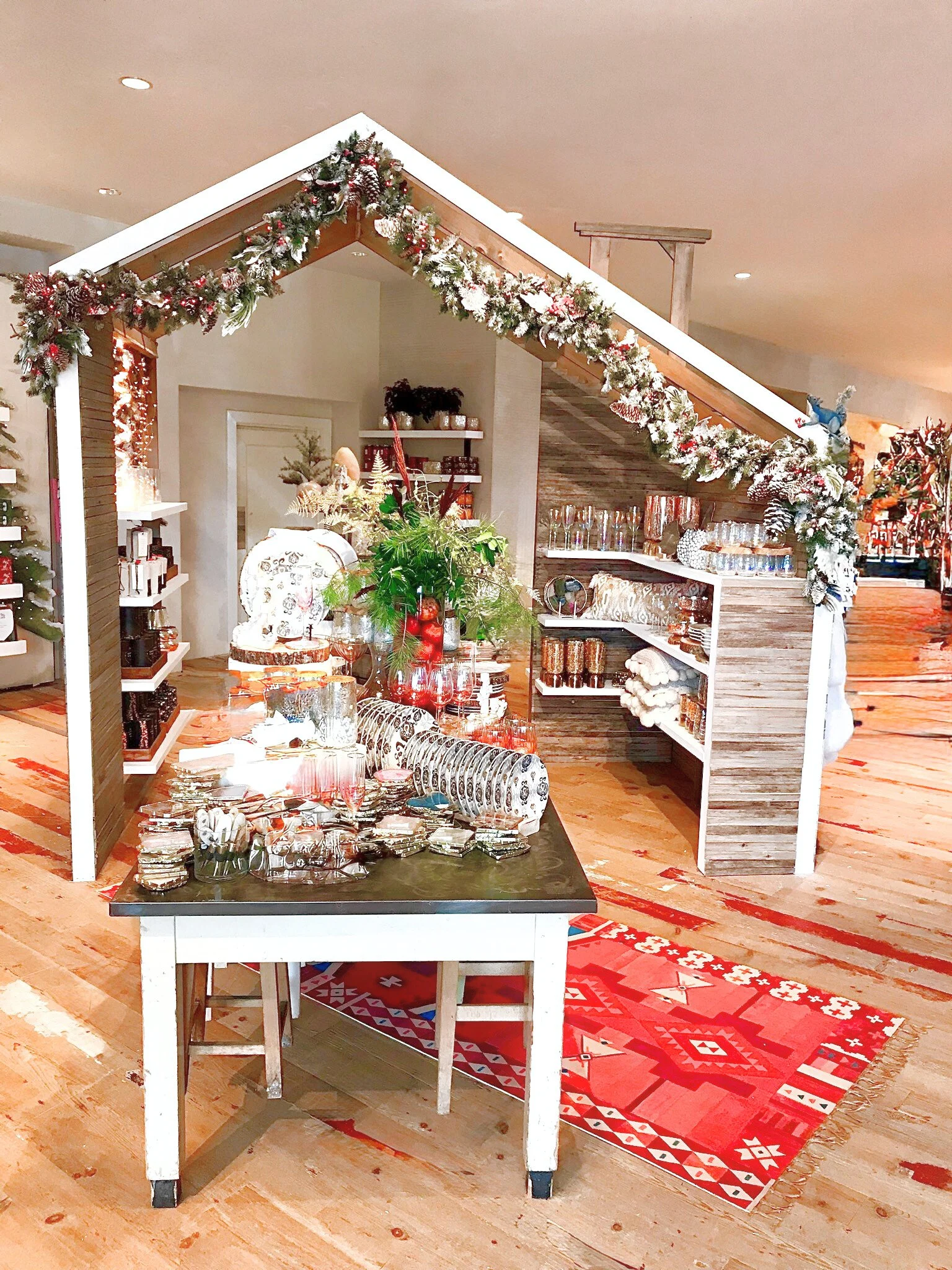 A cozy holiday cabin anchored the front of store.
