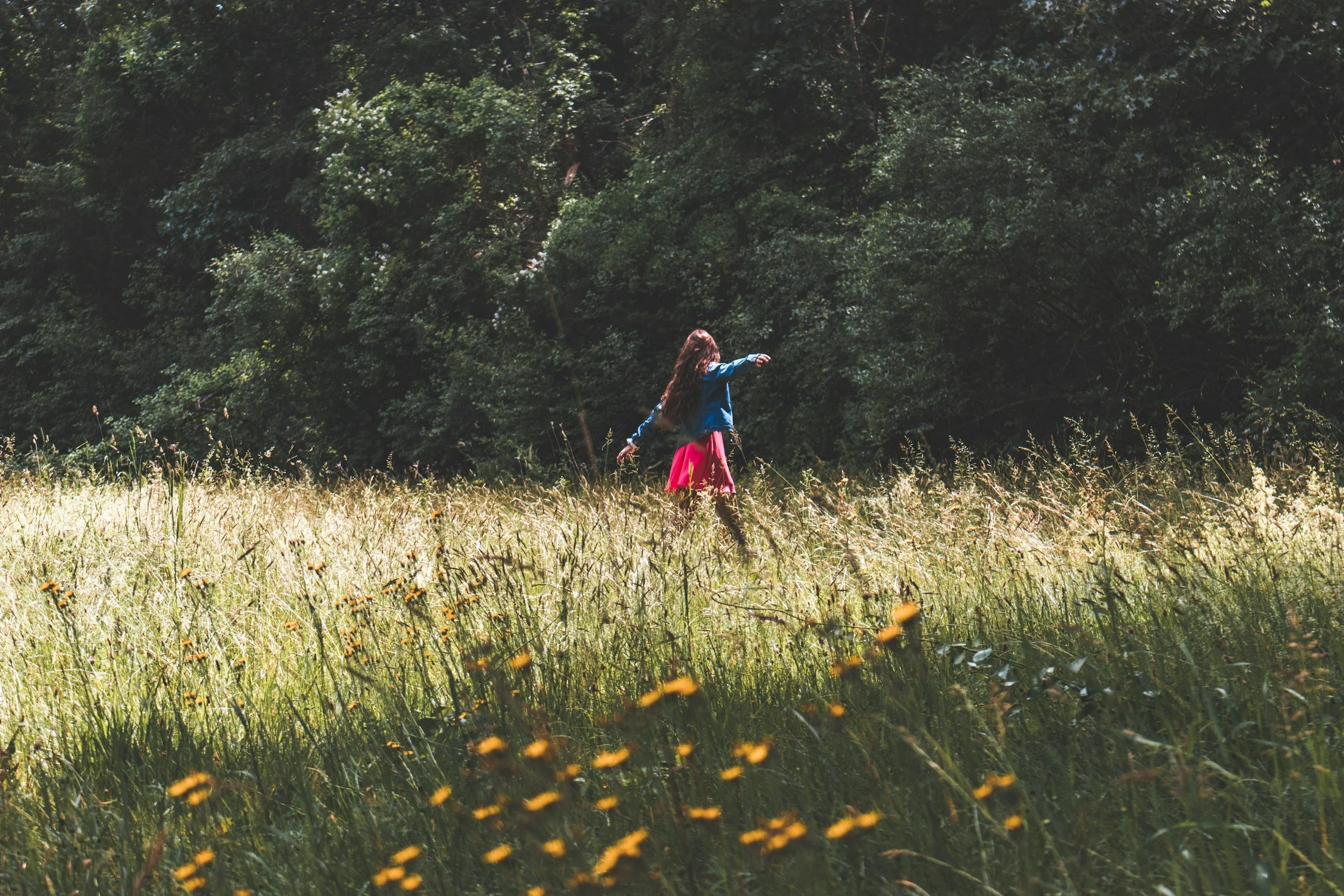 A young girl experiencing a field of flowers