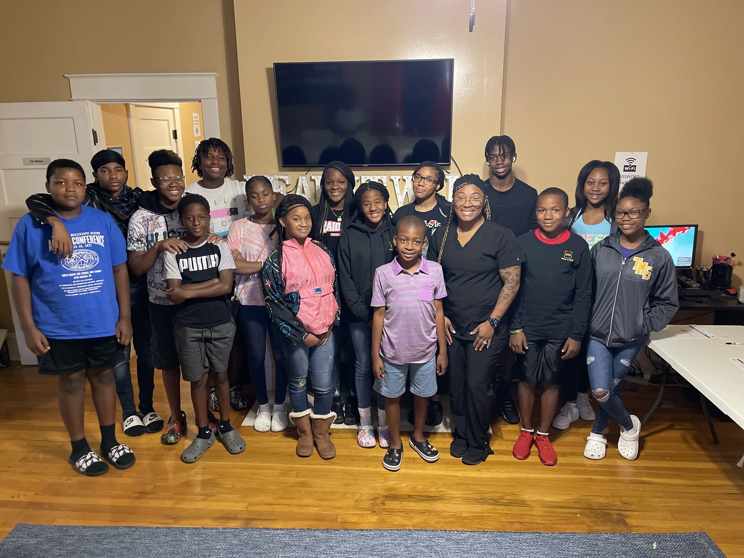 Keyshuna Cole pictured with kids and teens from the nonprofit Wear It Well after speaking event.