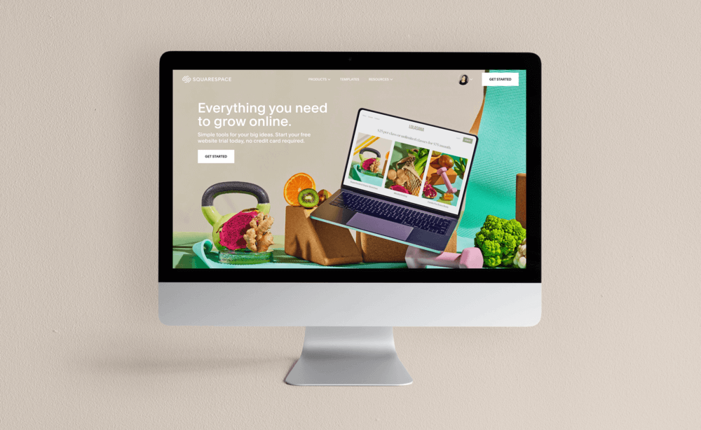 Silver iMac displaying Squarespace website on neutral tone background