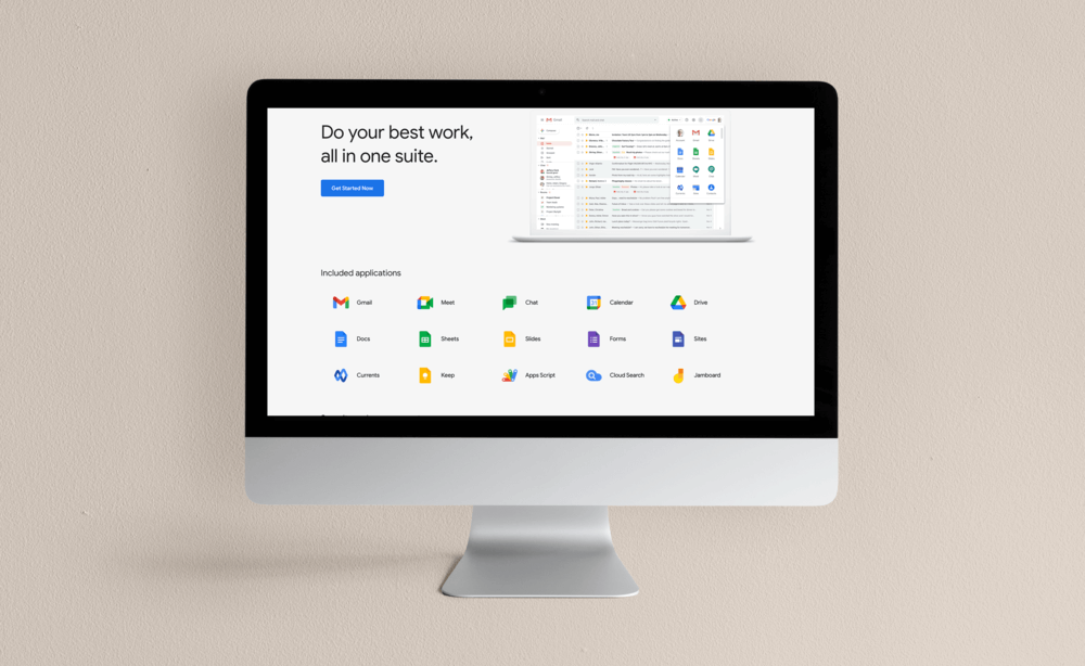 Silver iMac displaying Google Workspace website on neutral tone background.
