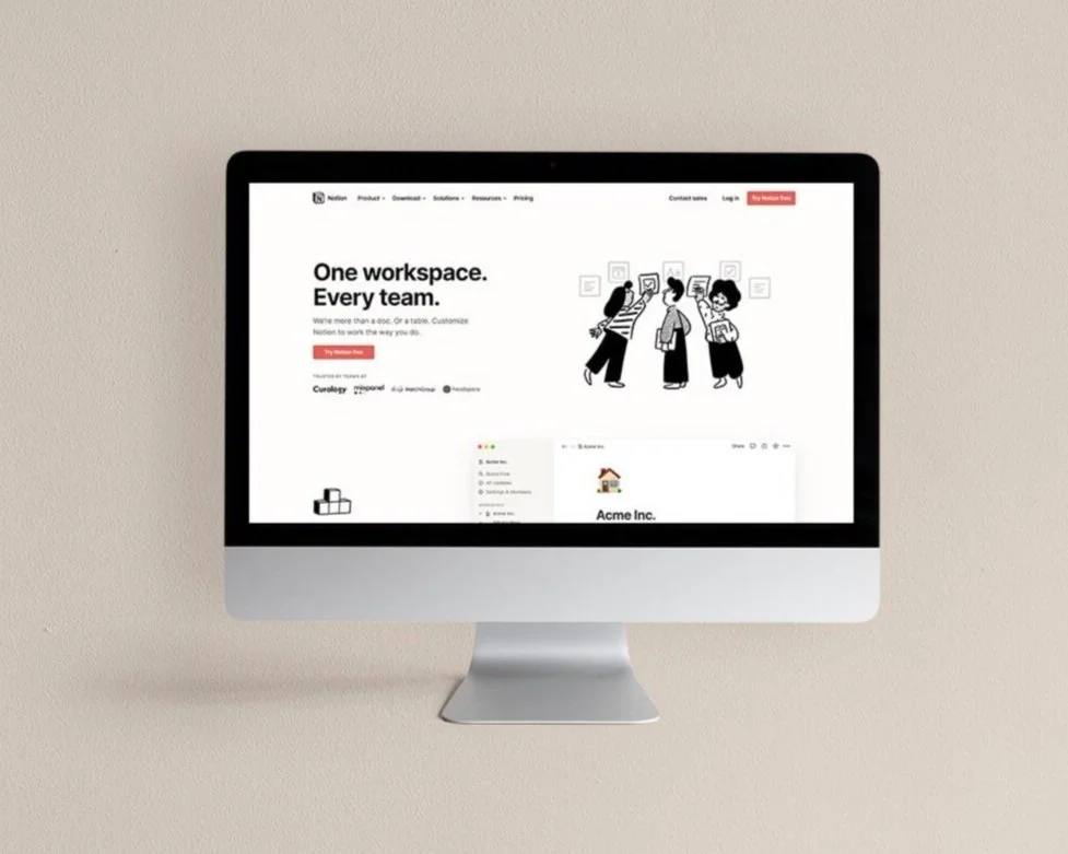 Silver iMac displaying Notion website on neutral tone background