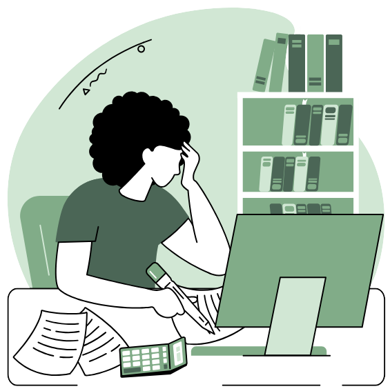 A person sitting at a computer with their head in their hands and papers scattered on their desk