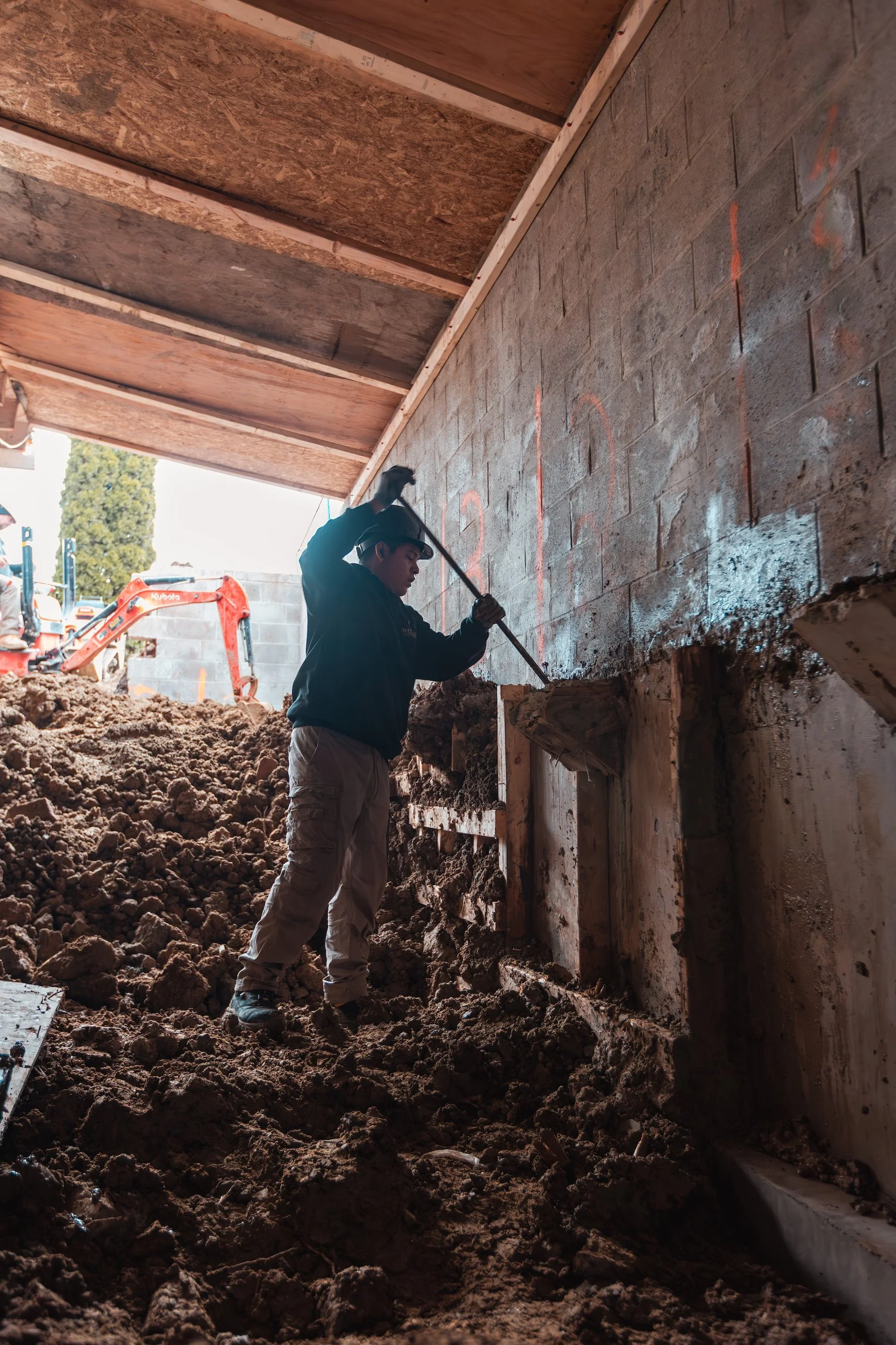underpinning-basement-digging-worker-shovel-trench.jpg